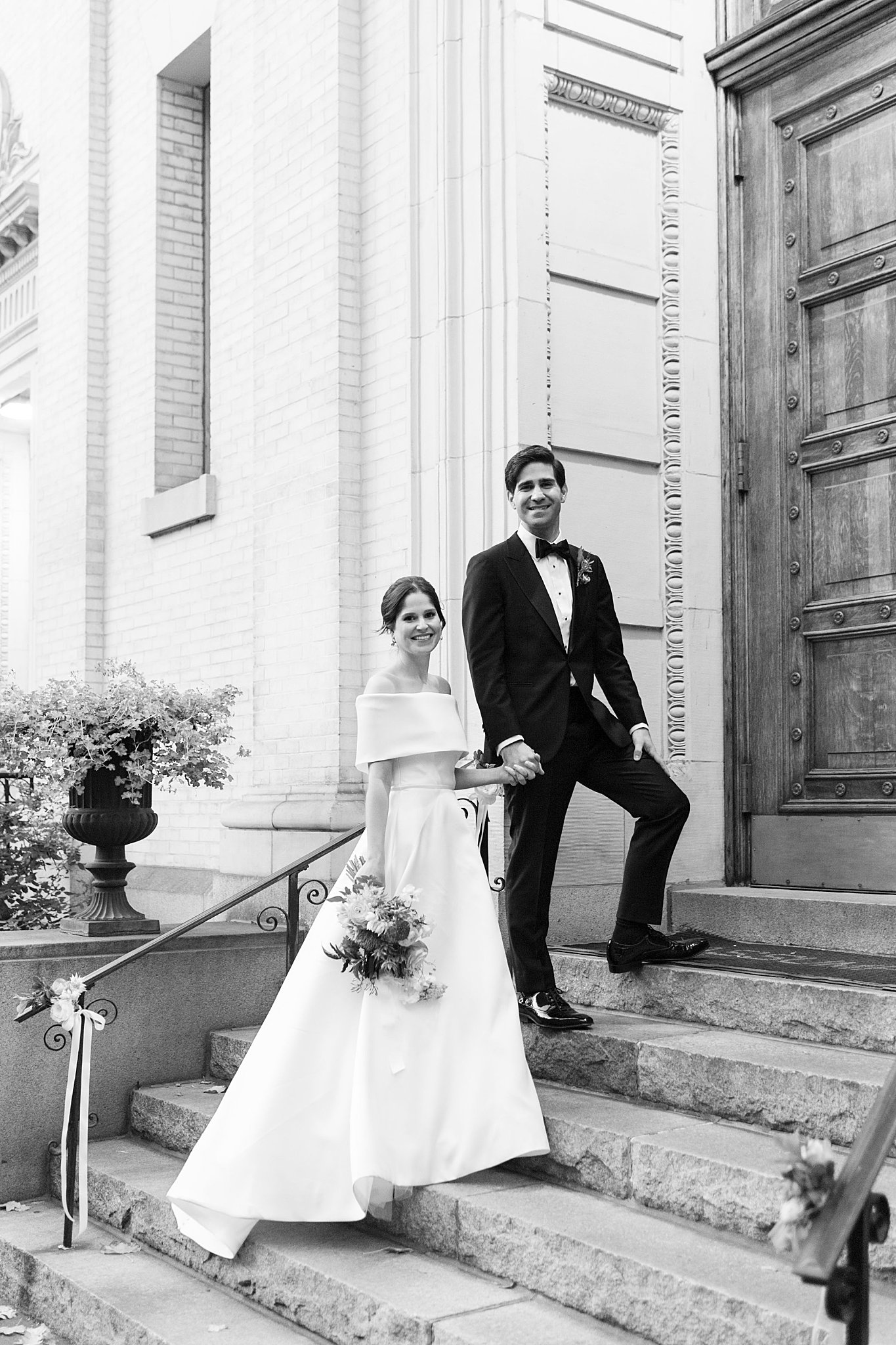 couple smiles outside church by Lynne Reznick Photography