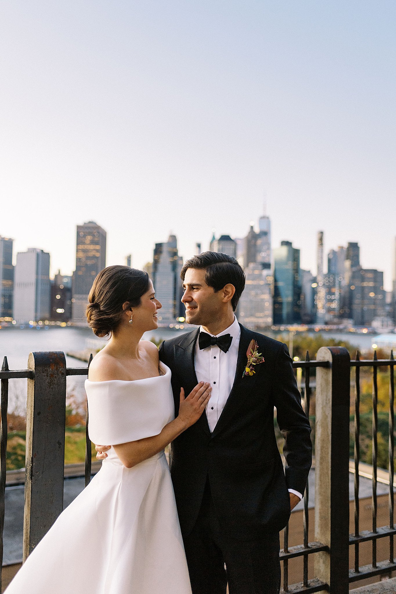 man and woman look at each other with skyline behind by Lynne Reznick Photography