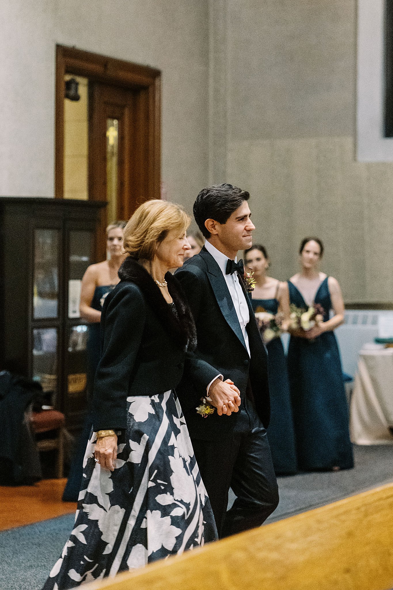 groom walks mom into ceremony by NYC wedding photographer 