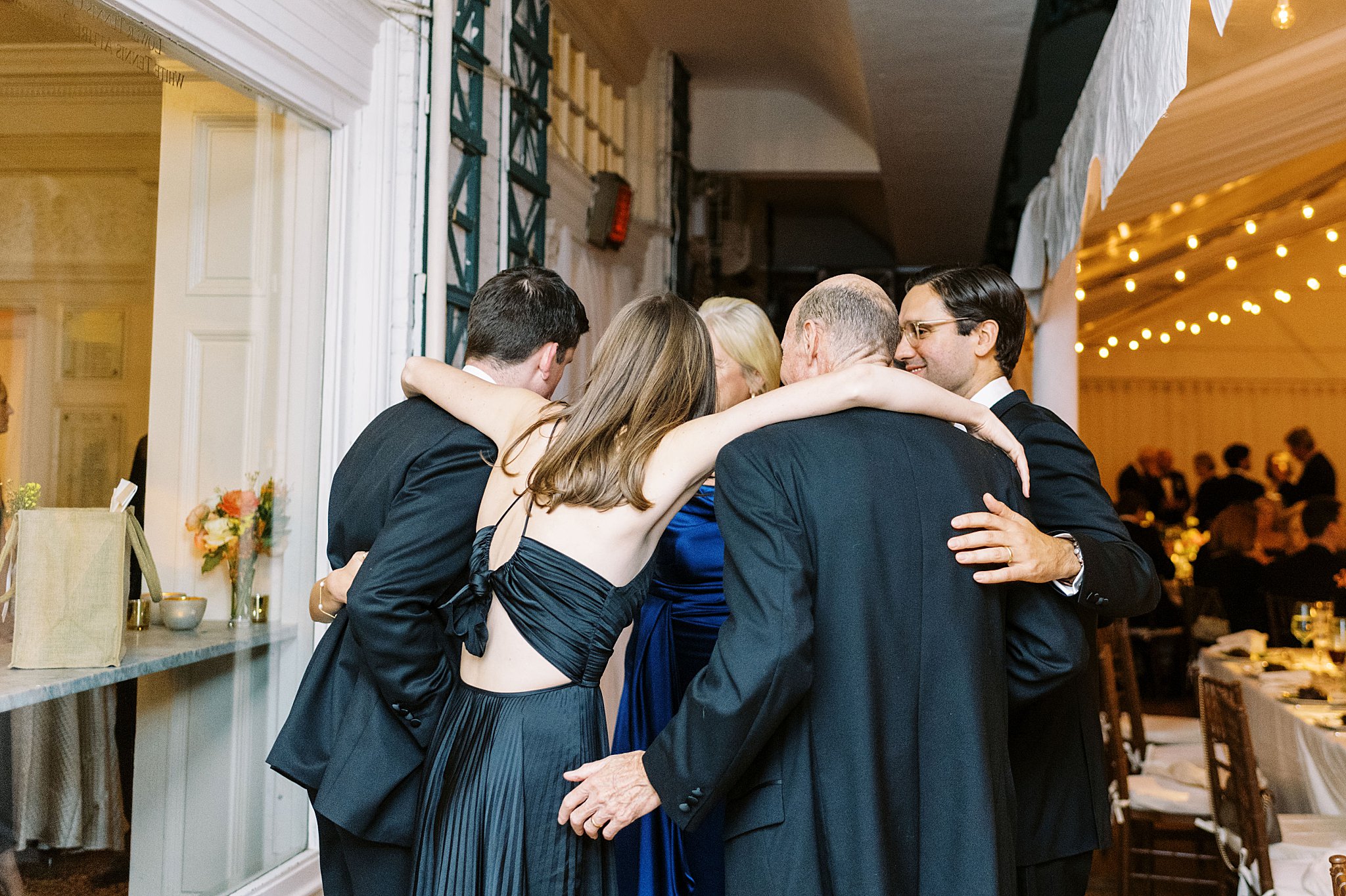 guests gather with arms around each other by Lynne Reznick Photography