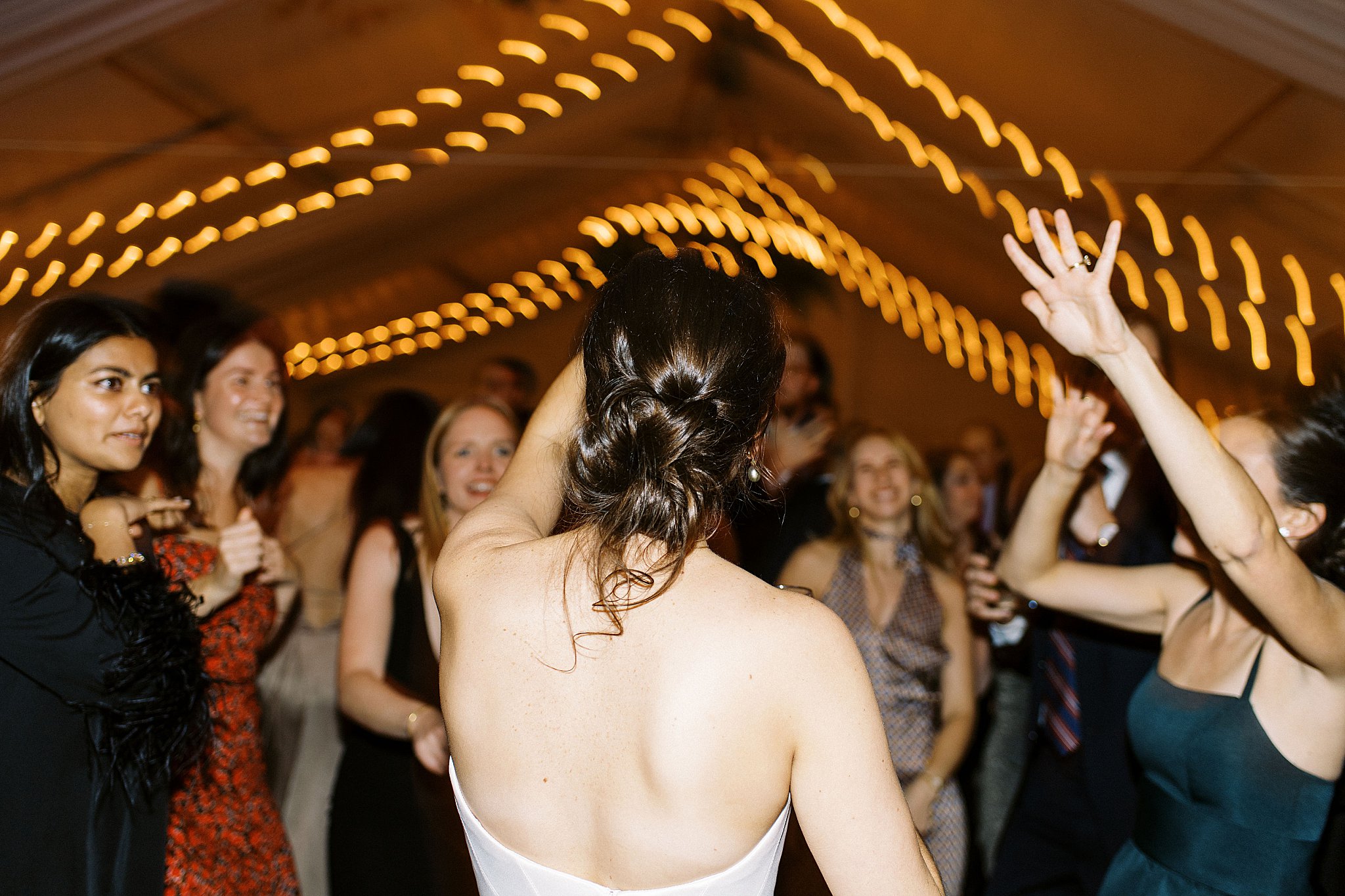 bride dances with friends as lights slide at Brooklyn Heights Casino