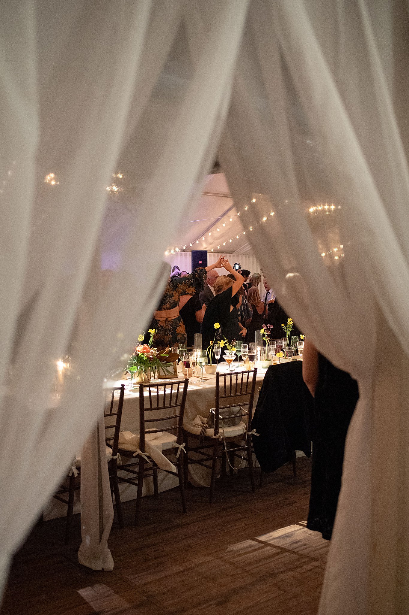 peek through curtains to dance floor at reception at Brooklyn Heights Casino