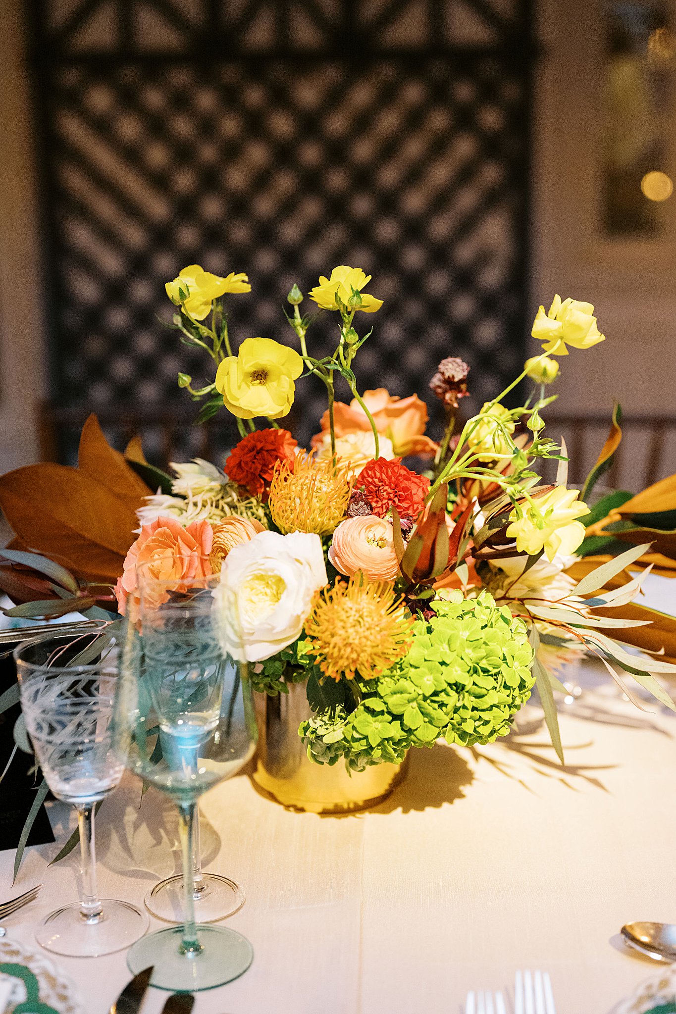 fall inspired florals in oranges and yellows adorn table at Brooklyn Heights Casino