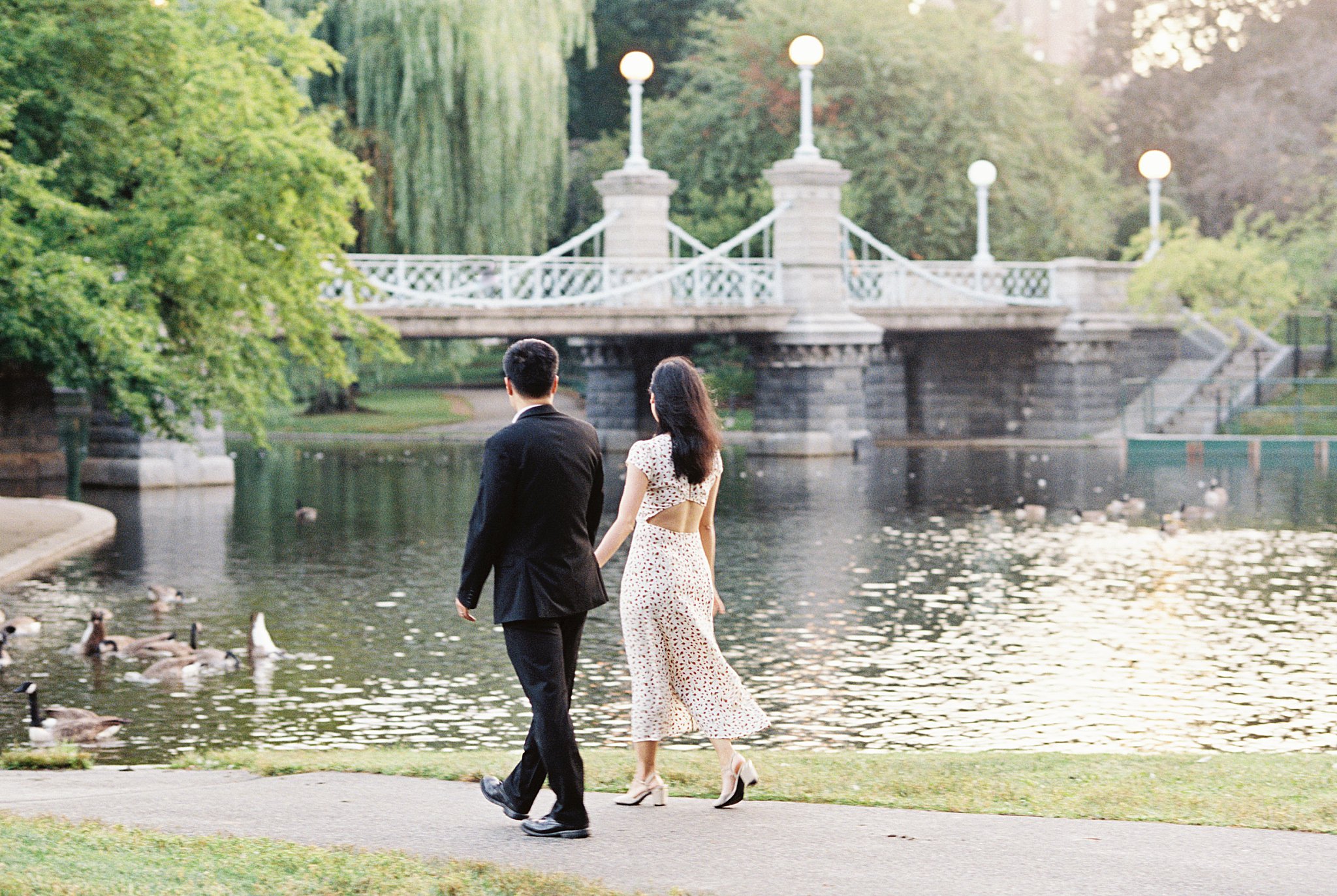 couple walks along path hand in hand at Public Garden Anniversary session