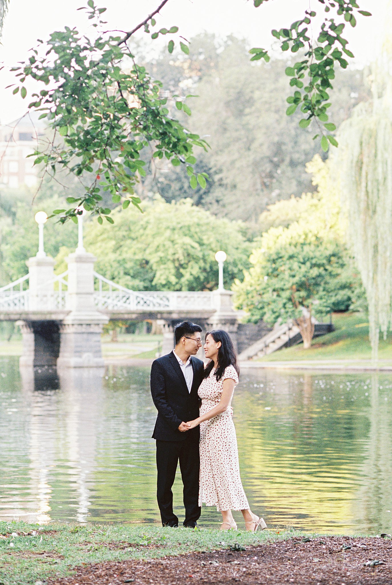 man and woman celebrate anniversary leaning close for a kiss by Lynne Reznick Photography