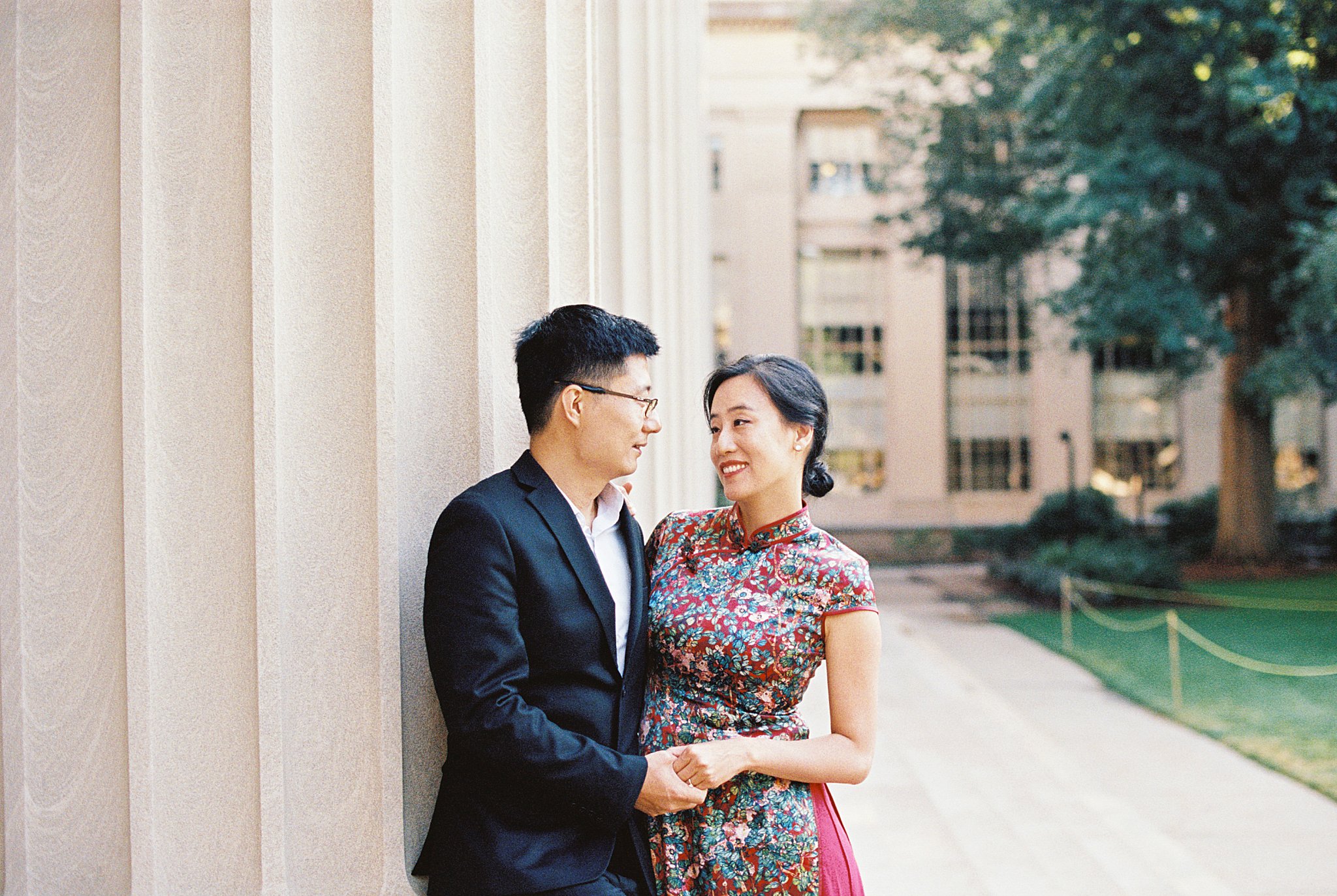 man holds woman's hand as they look at each other by Lynne Reznick Photography