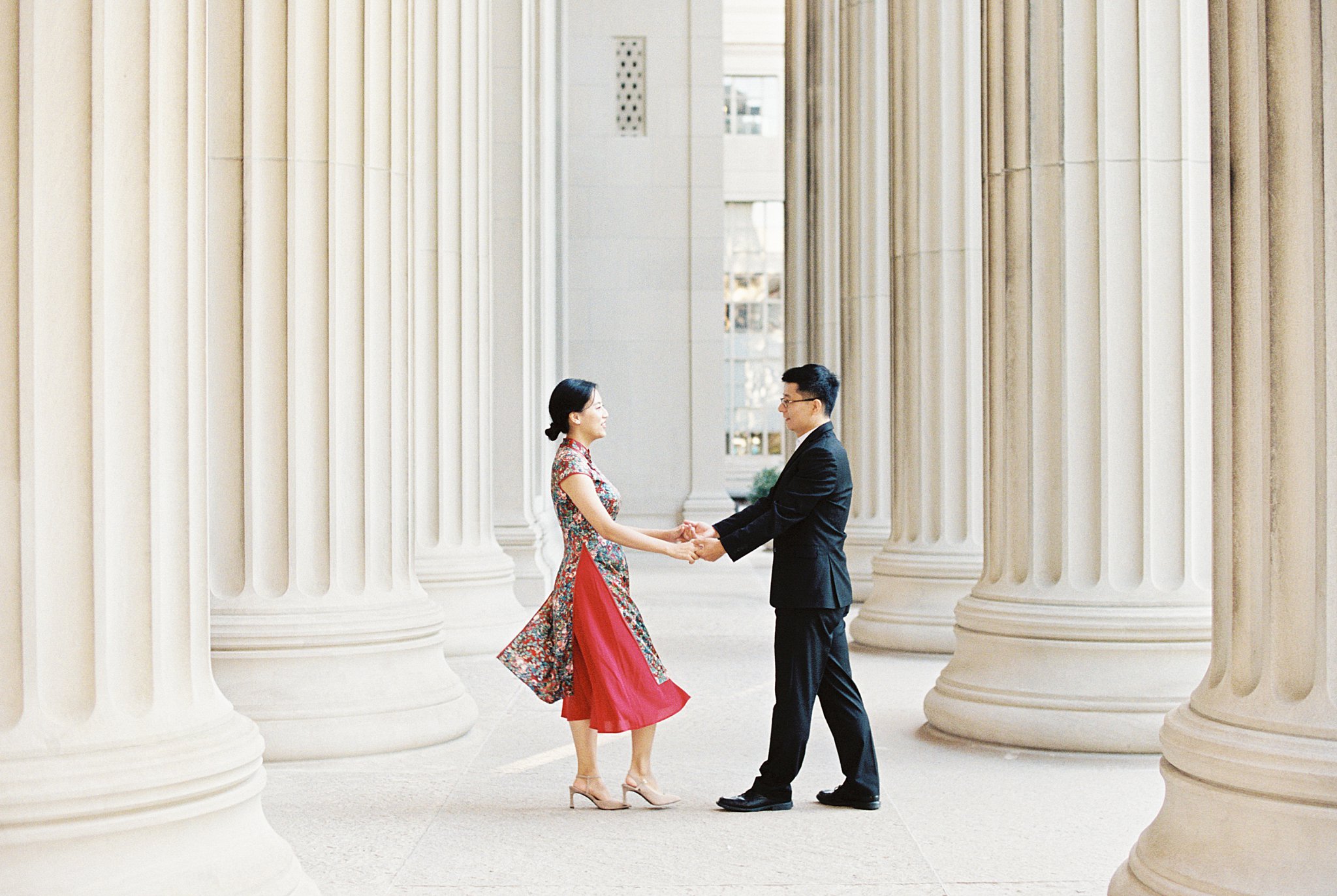 woman's dress flares as she spins holding hands with partner at Public Garden Anniversary session