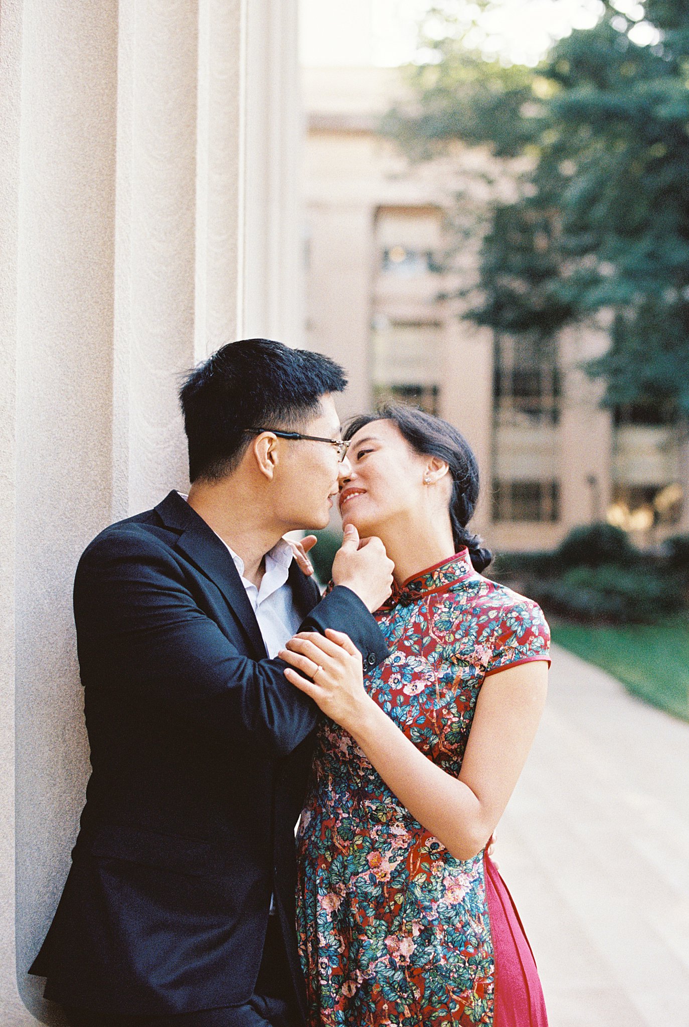 couple leans in for kiss as man puts hand on woman's chin at Public Garden Anniversary session