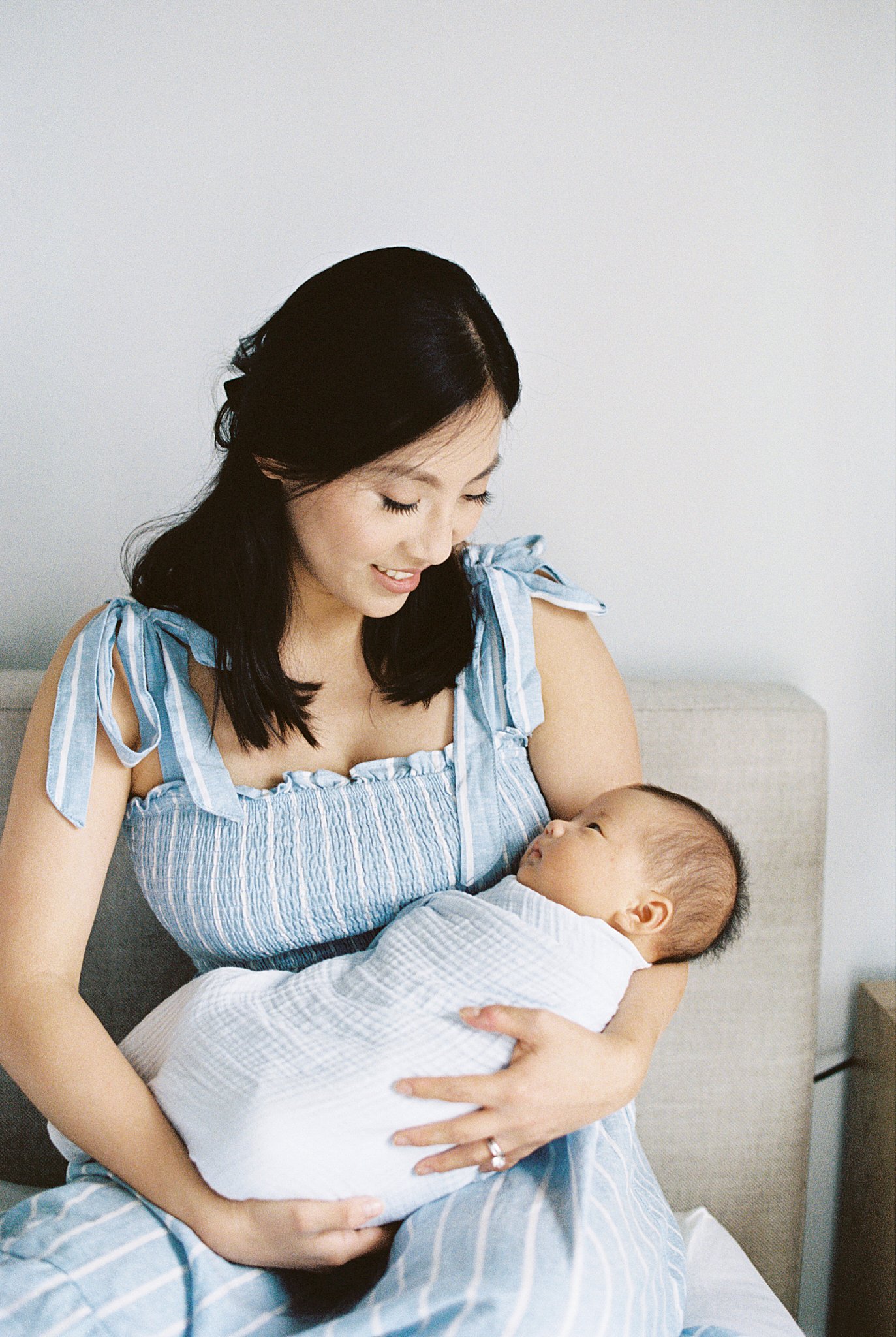 woman smiles down at her child by Lynne Reznick Photography