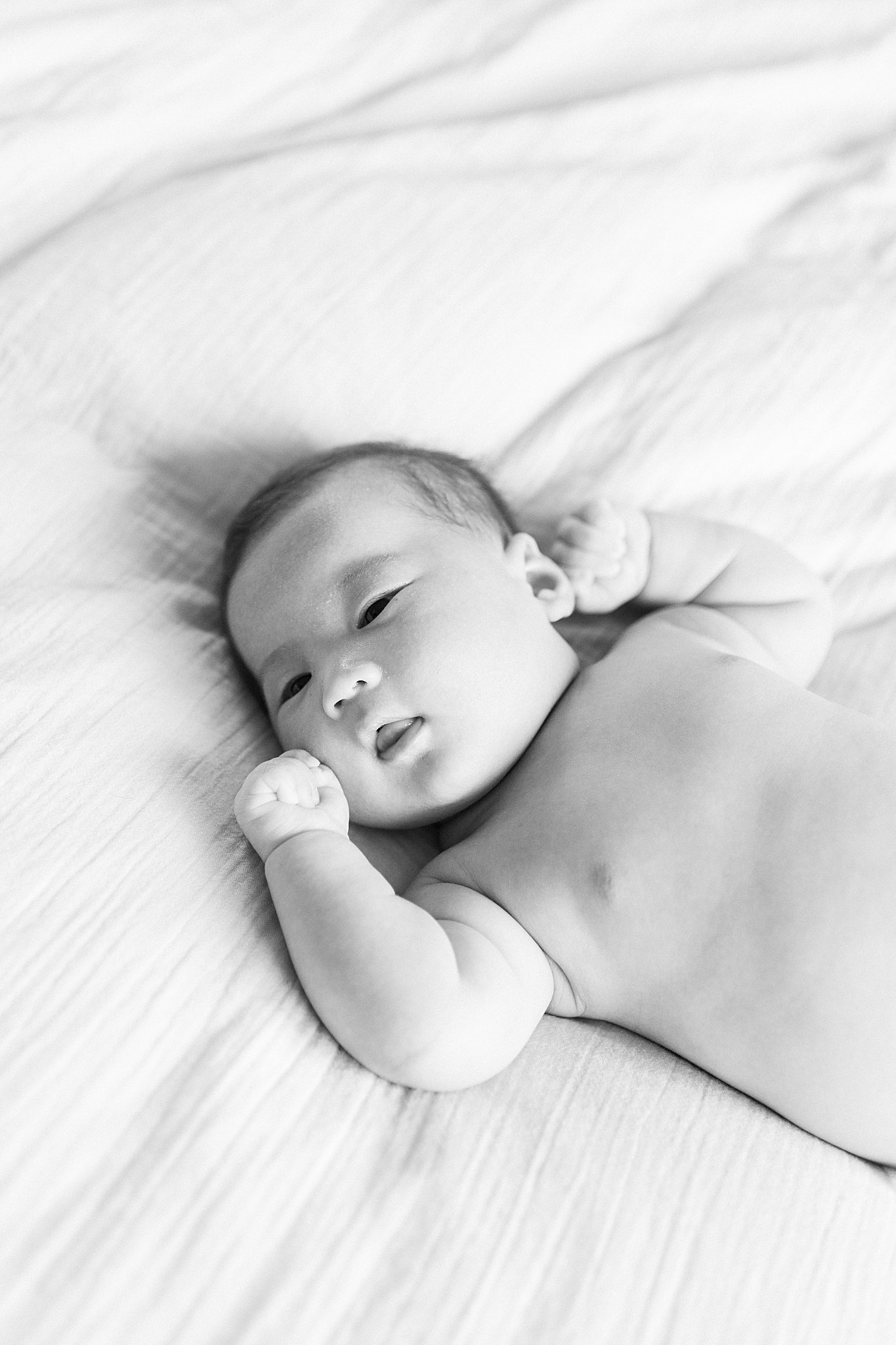 details of baby laying on bed by Boston family portrait photographer