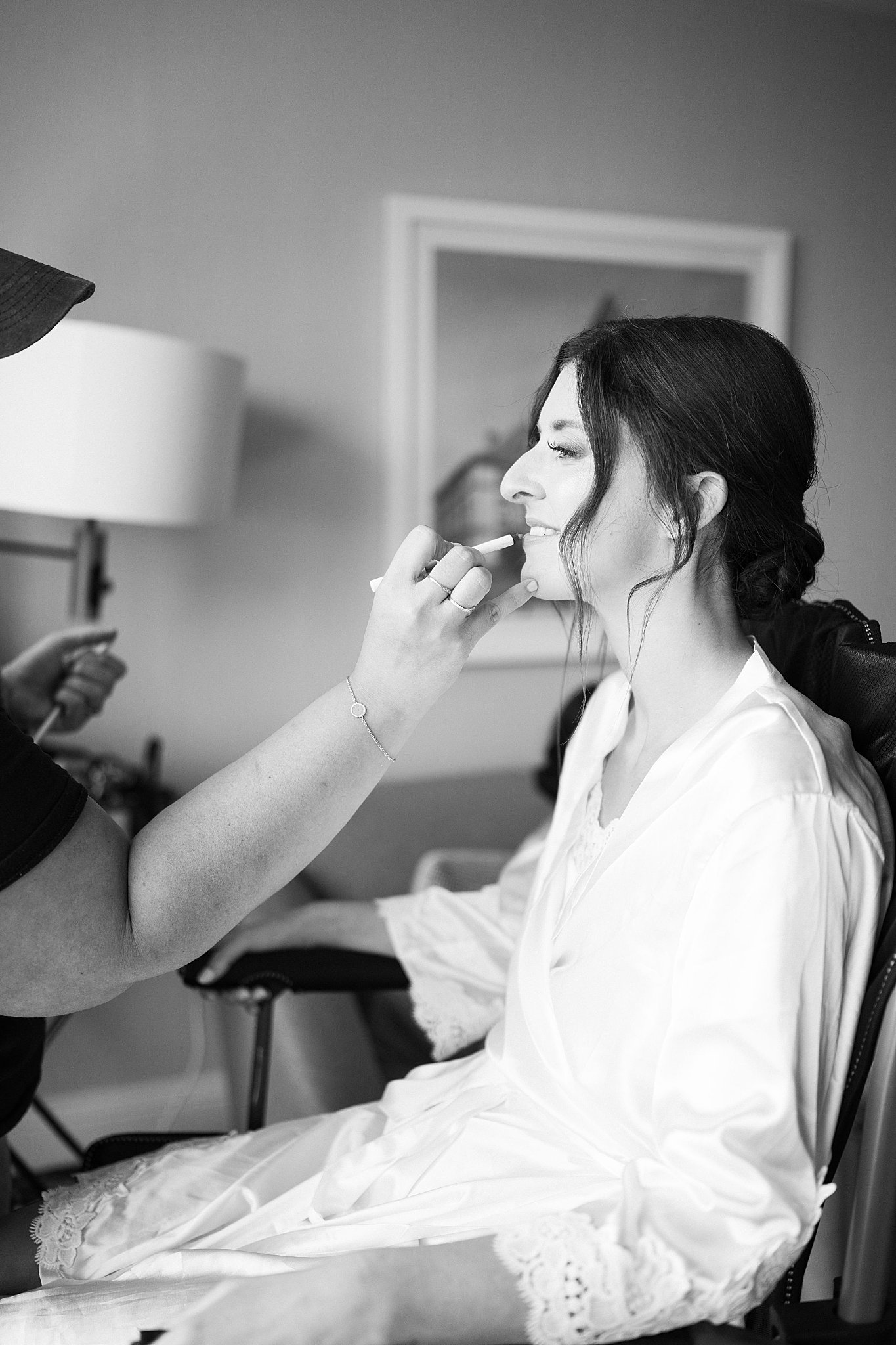 bride gets makeup applied for Museum of Science ceremony