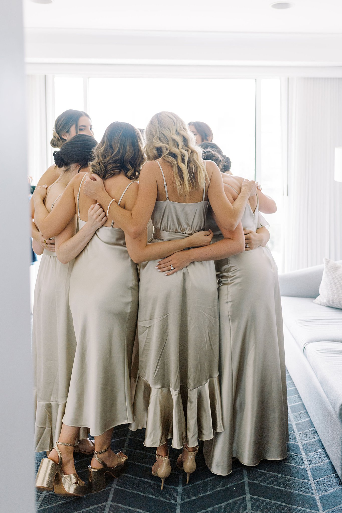 bridesmaids huddle together before Museum of Science ceremony