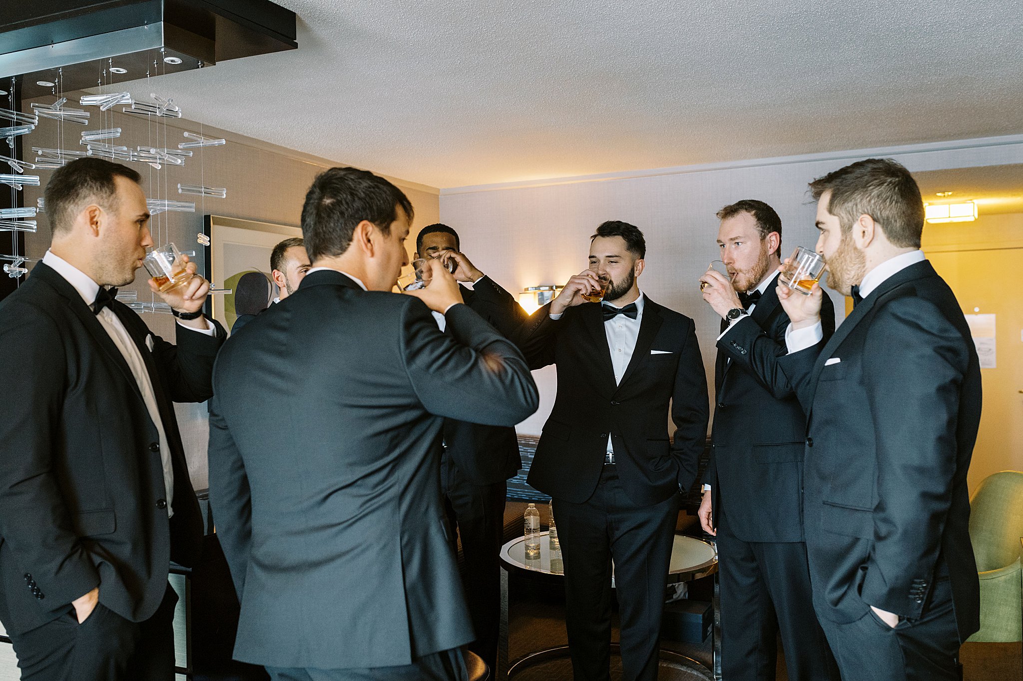 groomsmen share a drink by Lynne Reznick Photography