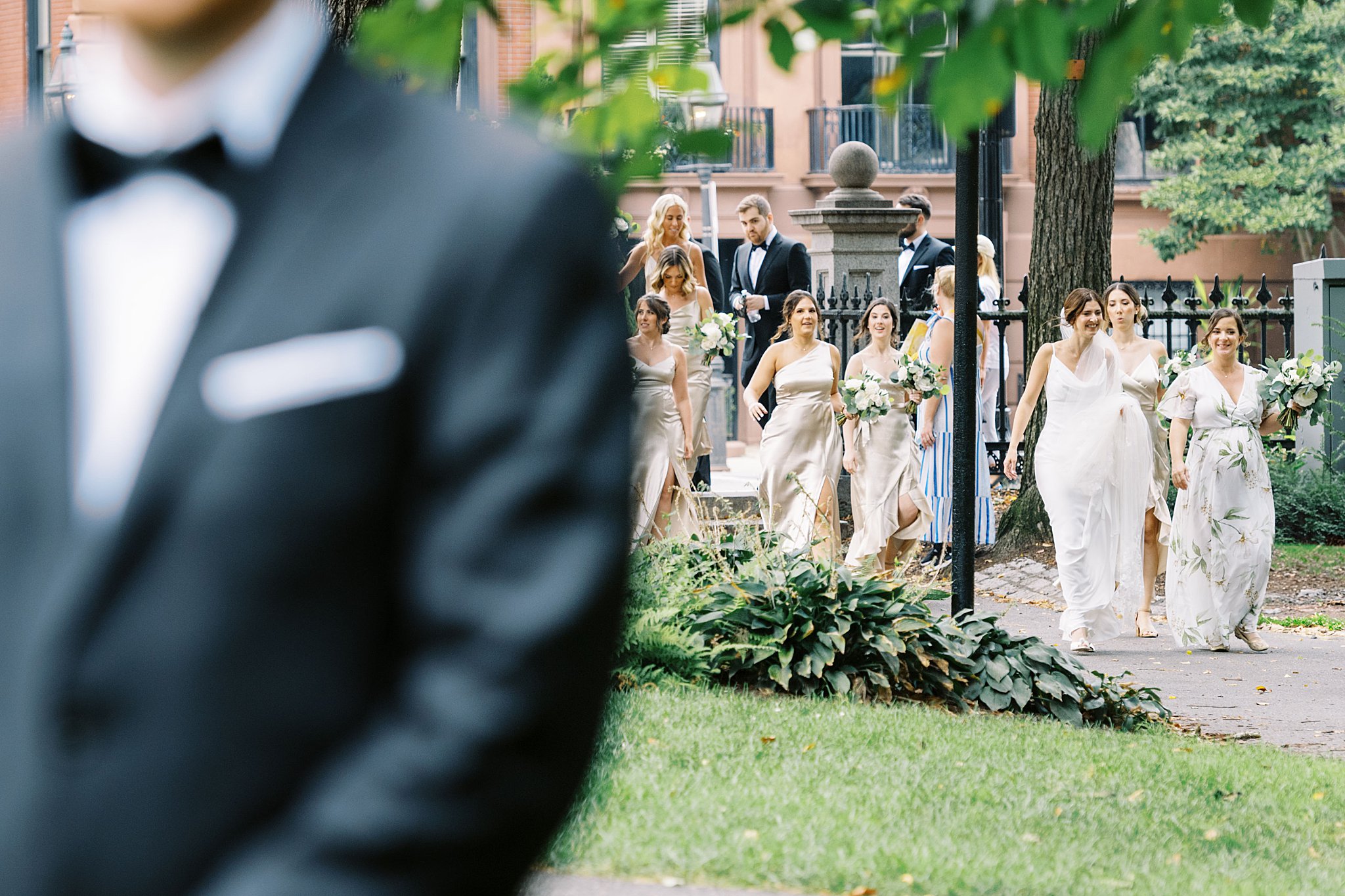 wedding party walks with bride to groom for first look before Museum of Science ceremony