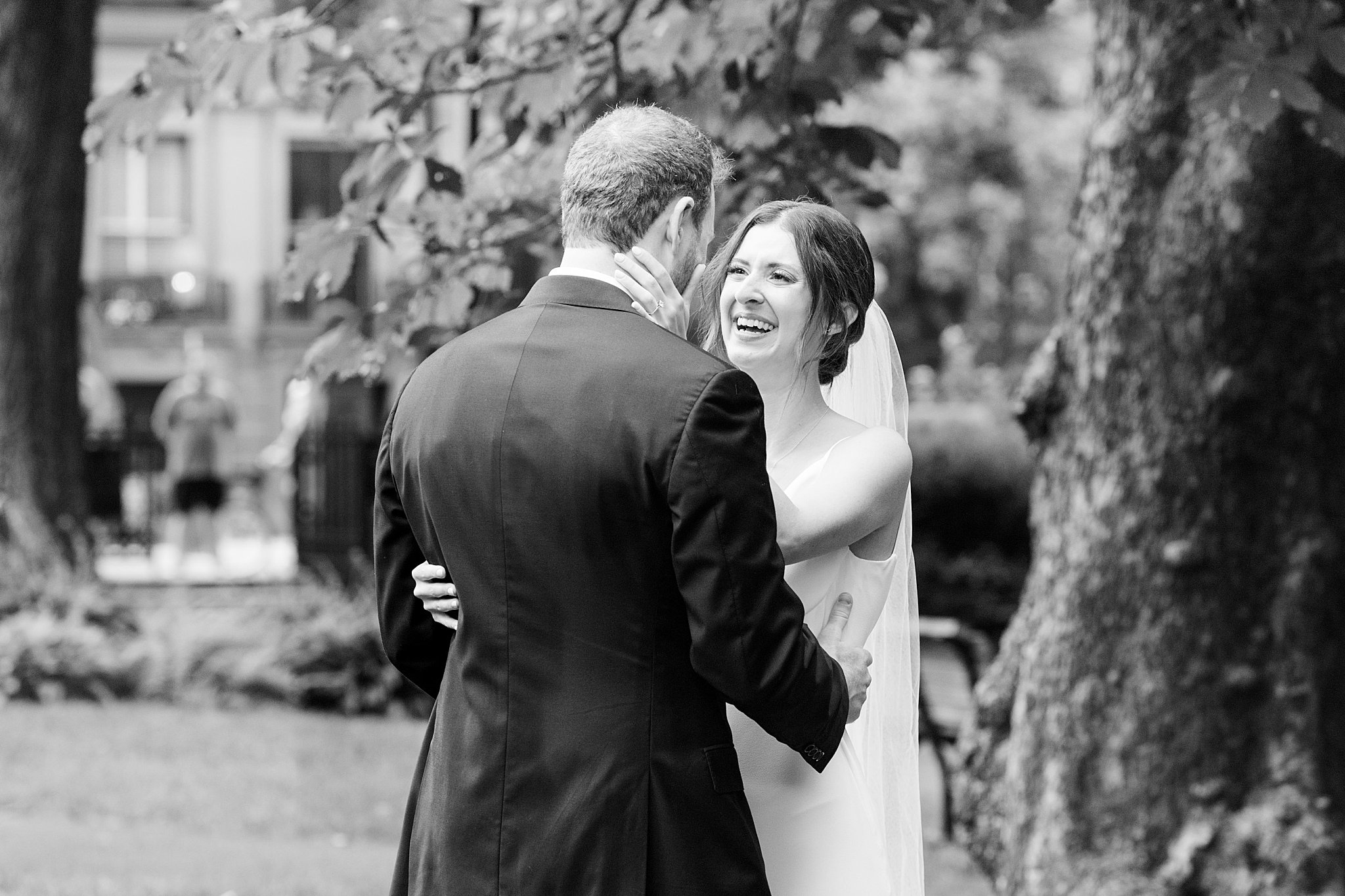 couple smiles and holds each other by Boston Wedding Photographer