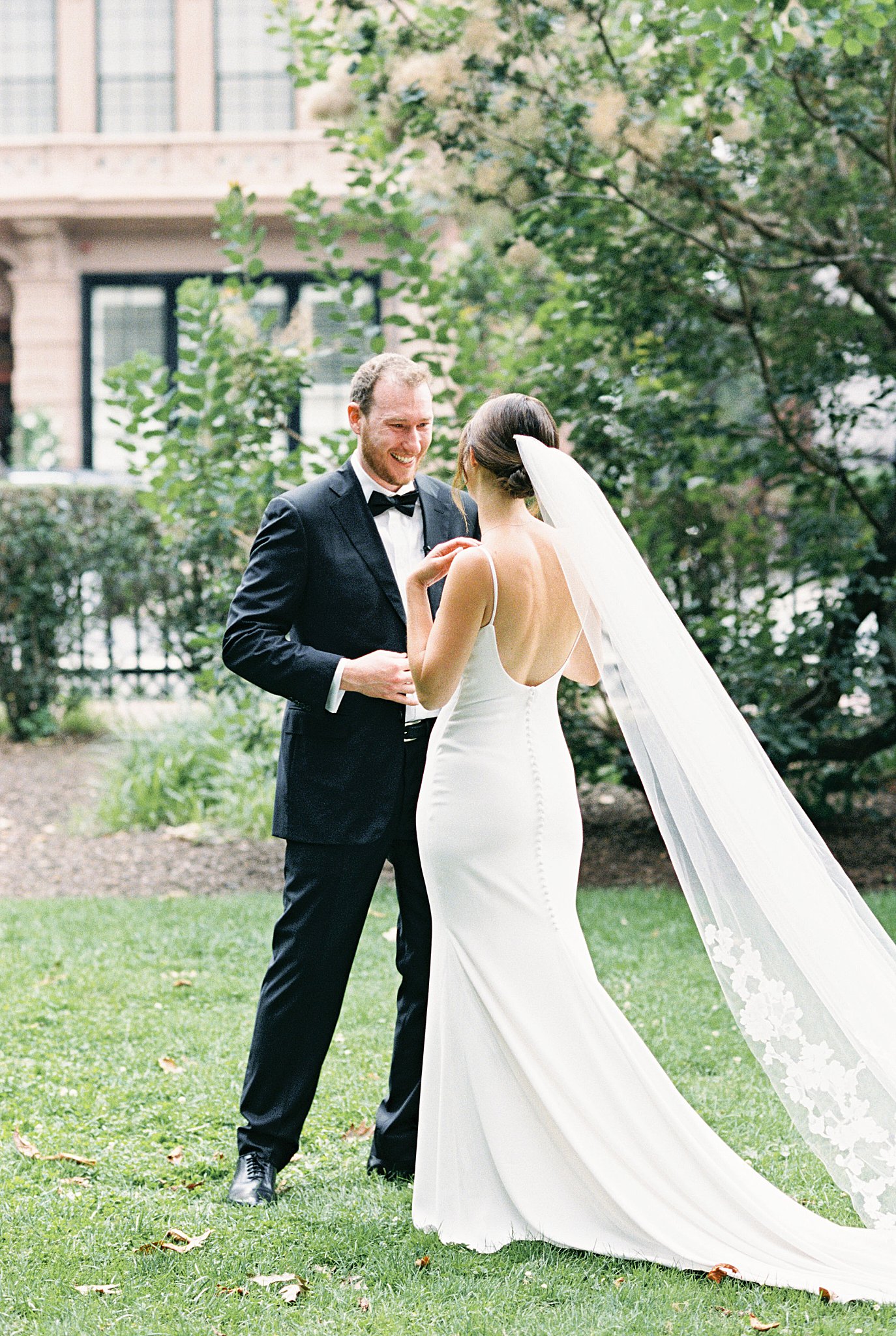 man smiles at woman in gown by Lynne Reznick Photography