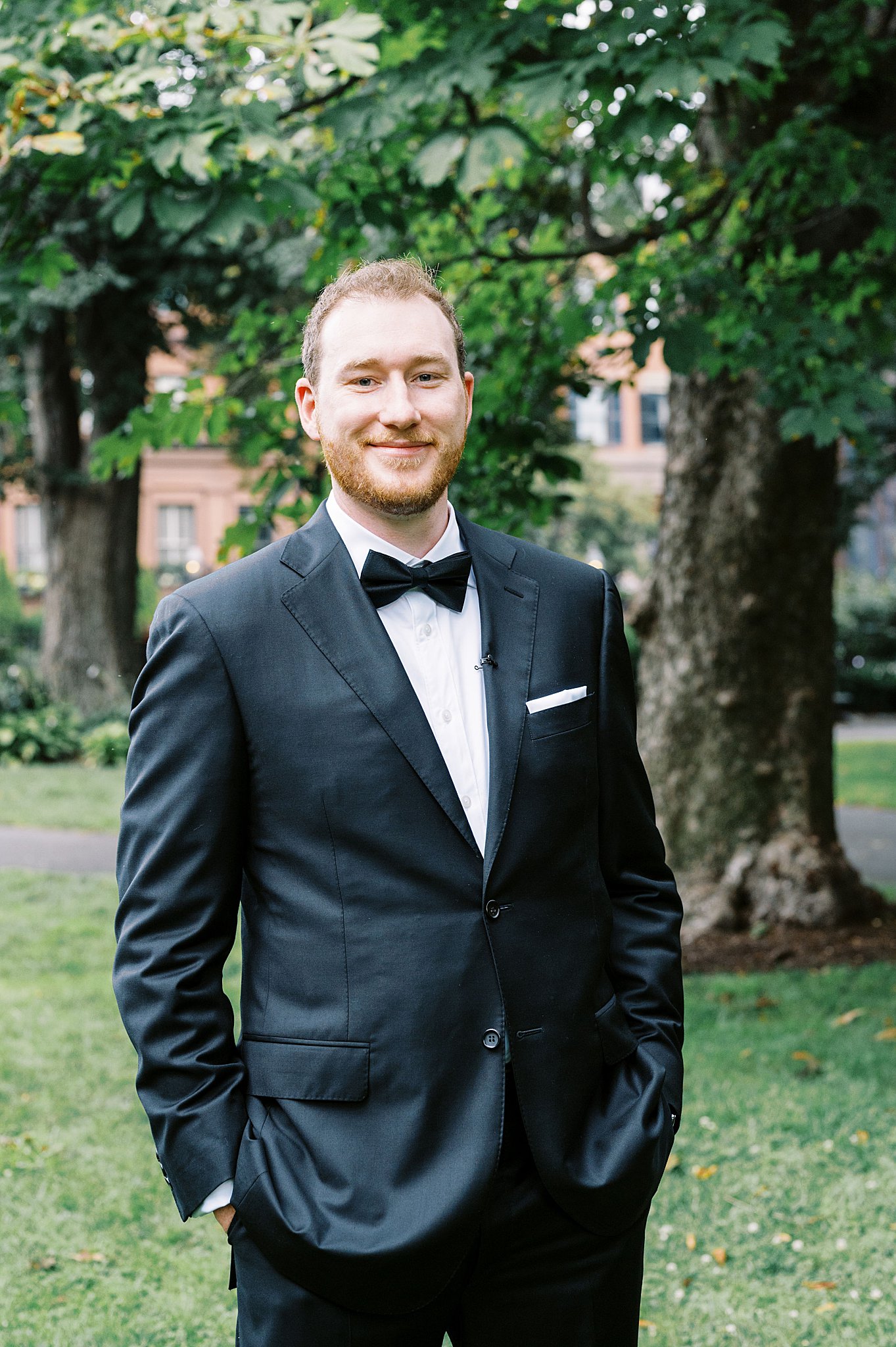 groom puts hands in pockets by Boston Wedding Photographer