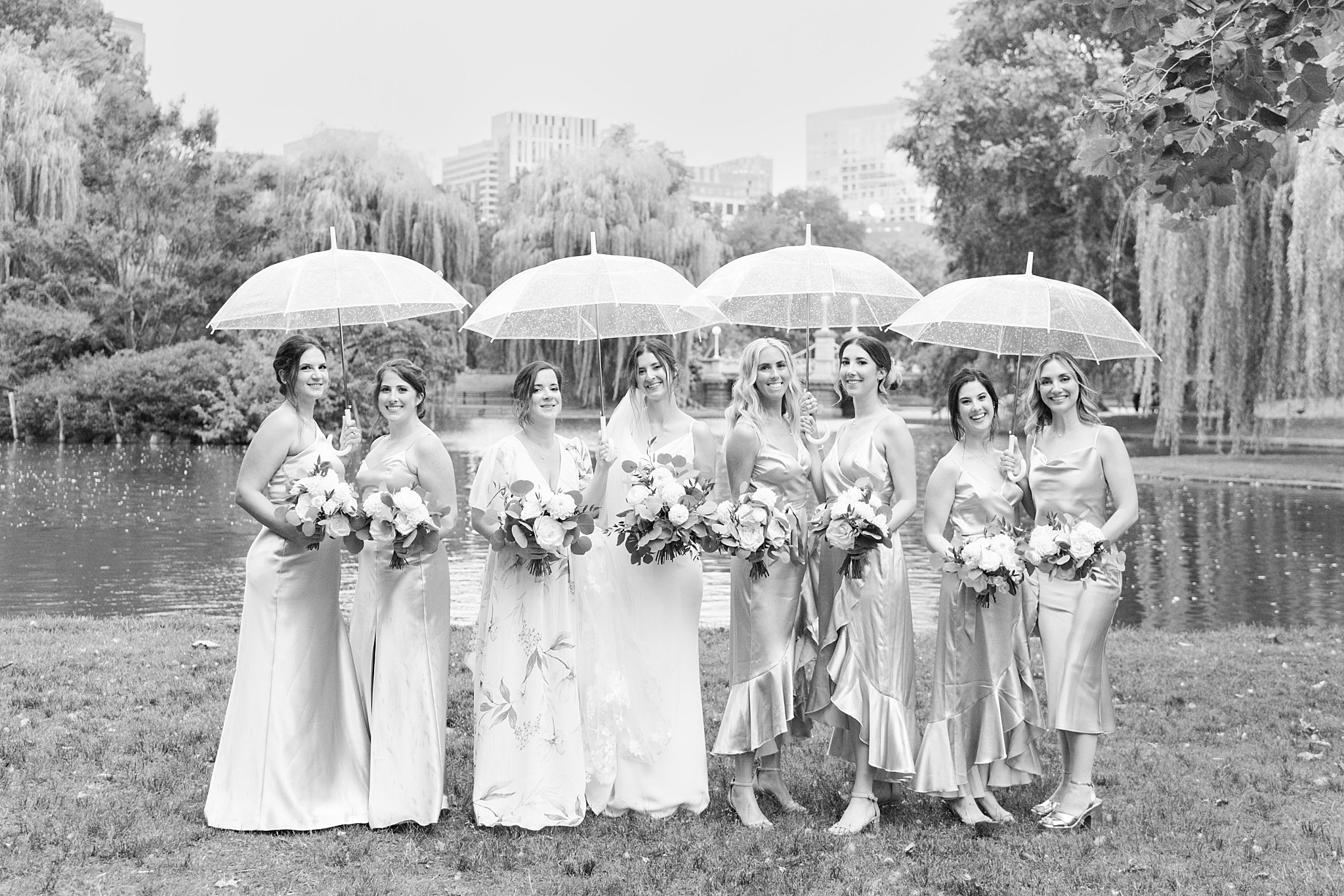 bridesmaids gather under umbreallas before Museum of Science ceremony