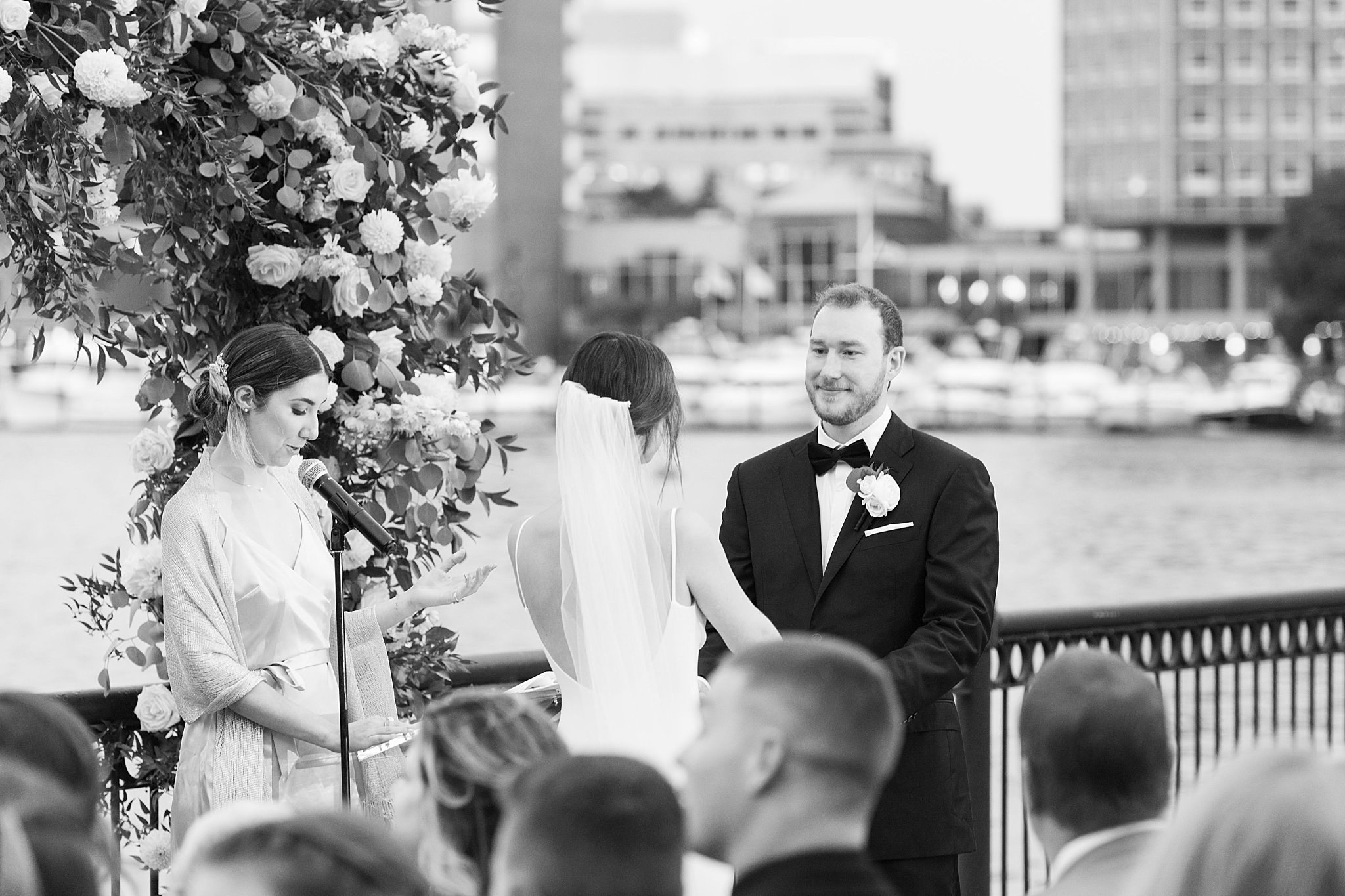 bride and groom hold hands as they exchange vows at Museum of Science ceremony