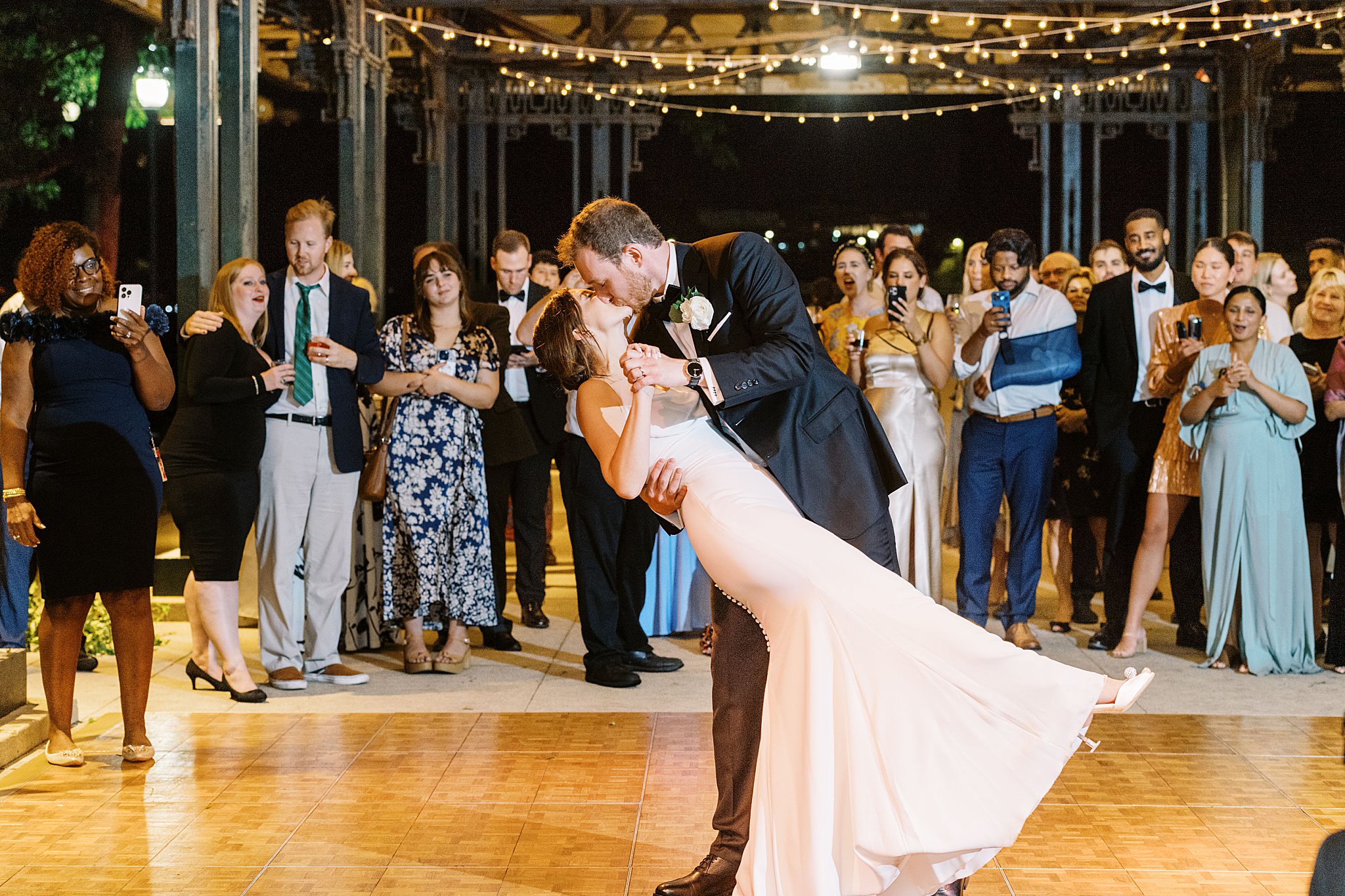 newlyweds kiss as they dip during first dance by Boston Wedding Photographer