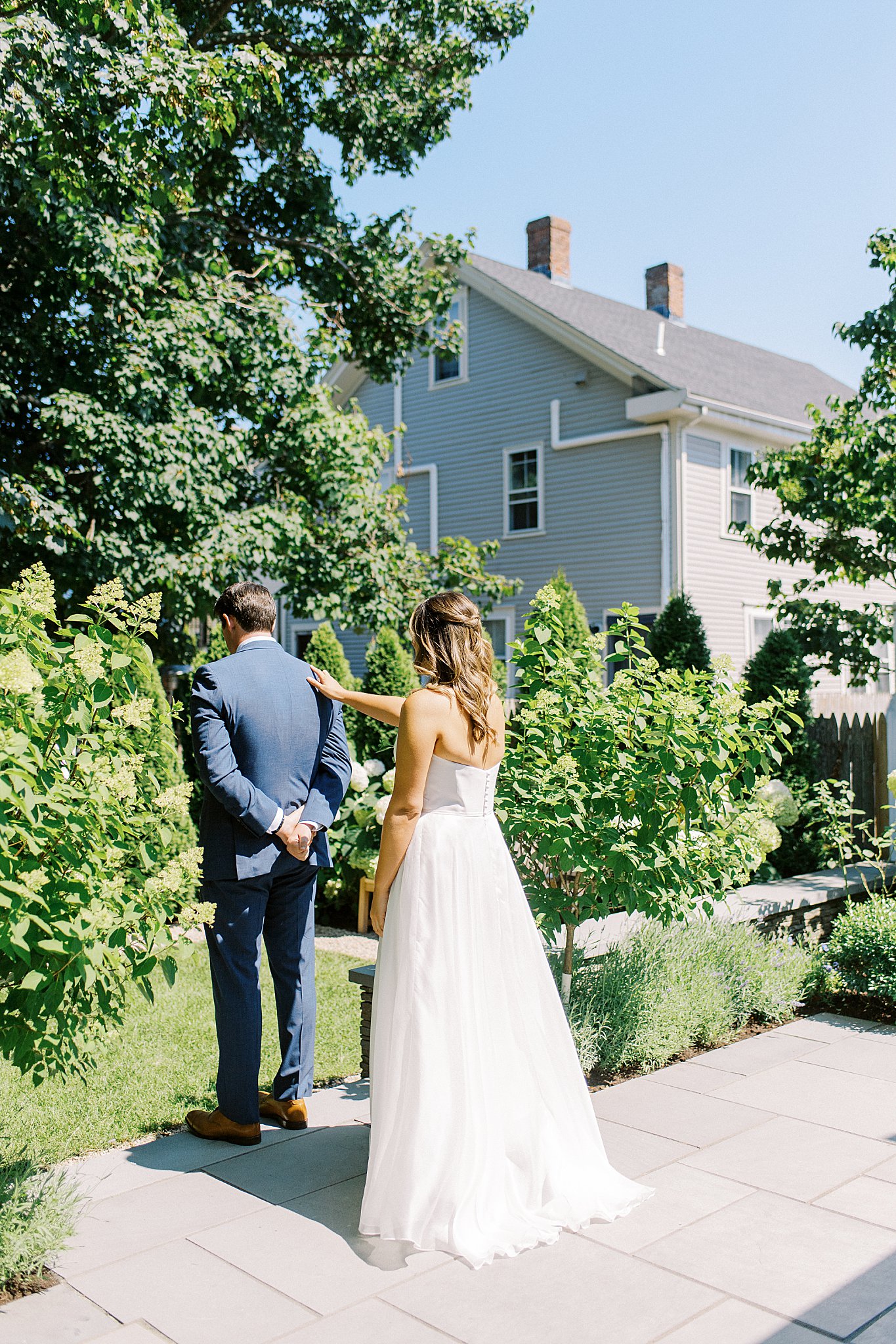 woman taps man on shoulder for first look by Lynne Reznick Photography