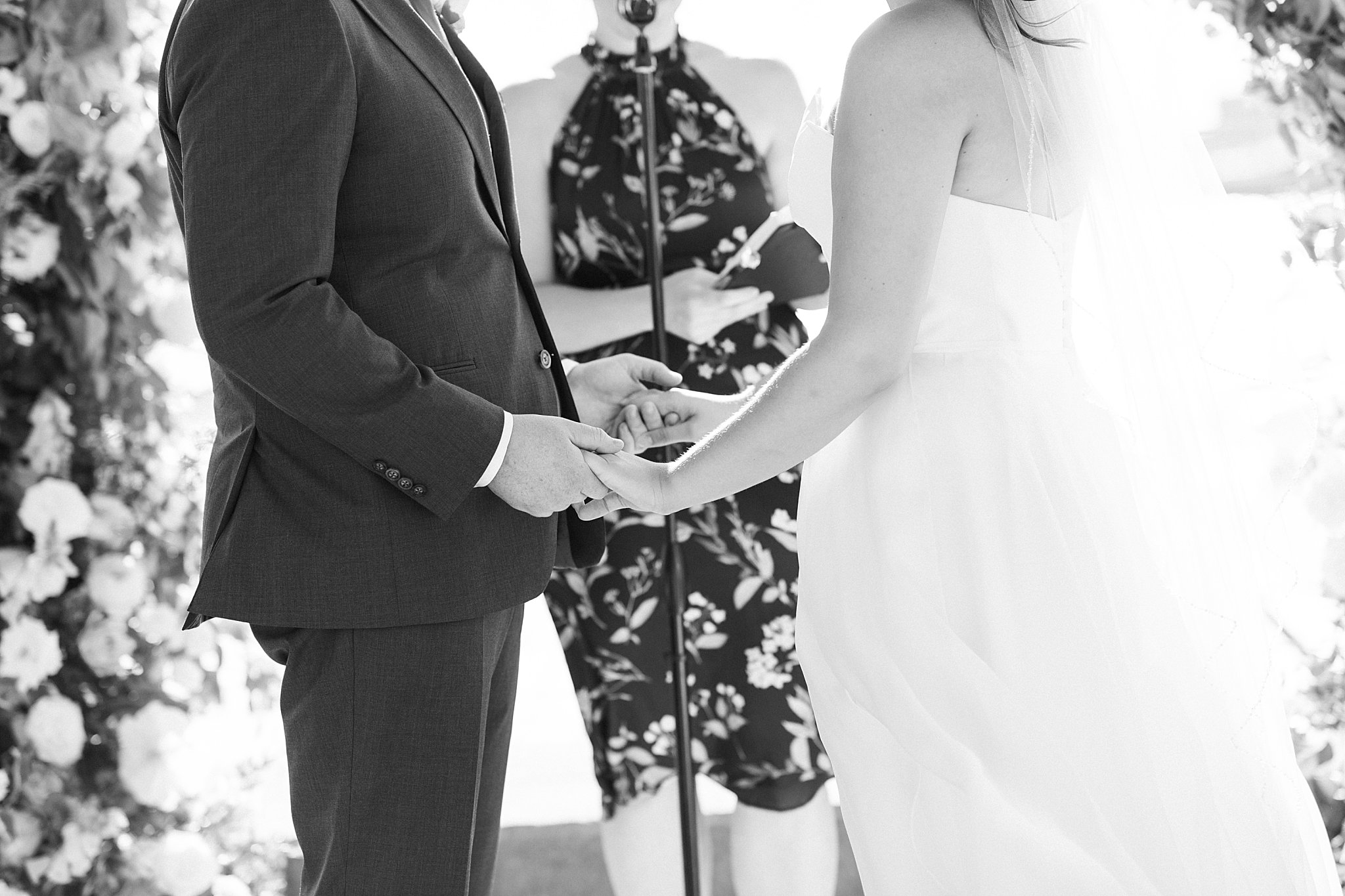 couple holds hands together at altar by Lynne Reznick Photography