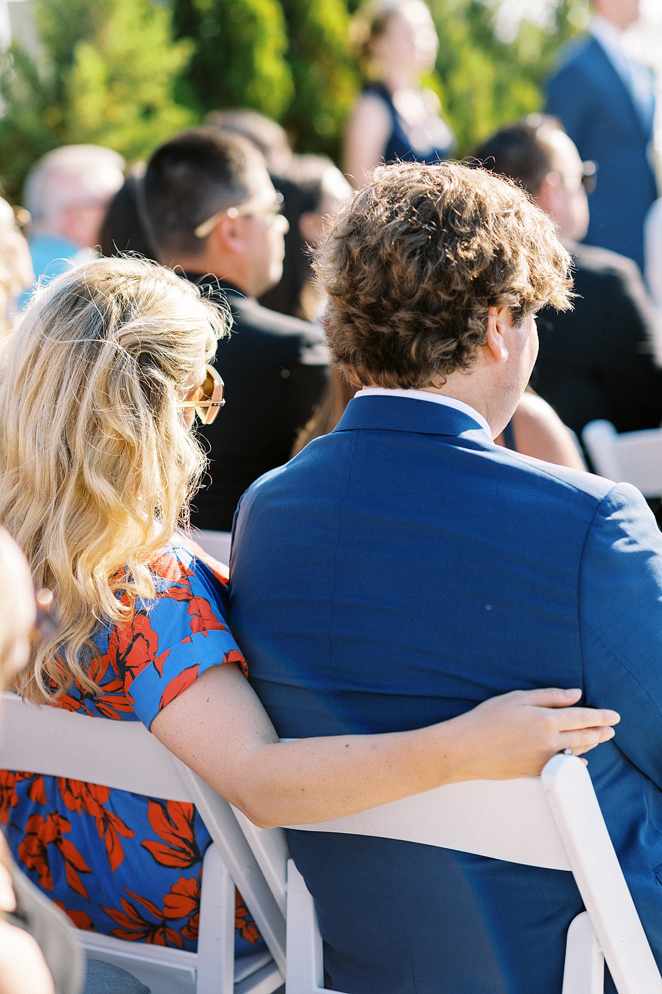 guests watch ceremony with arms around each other at The Bohlin