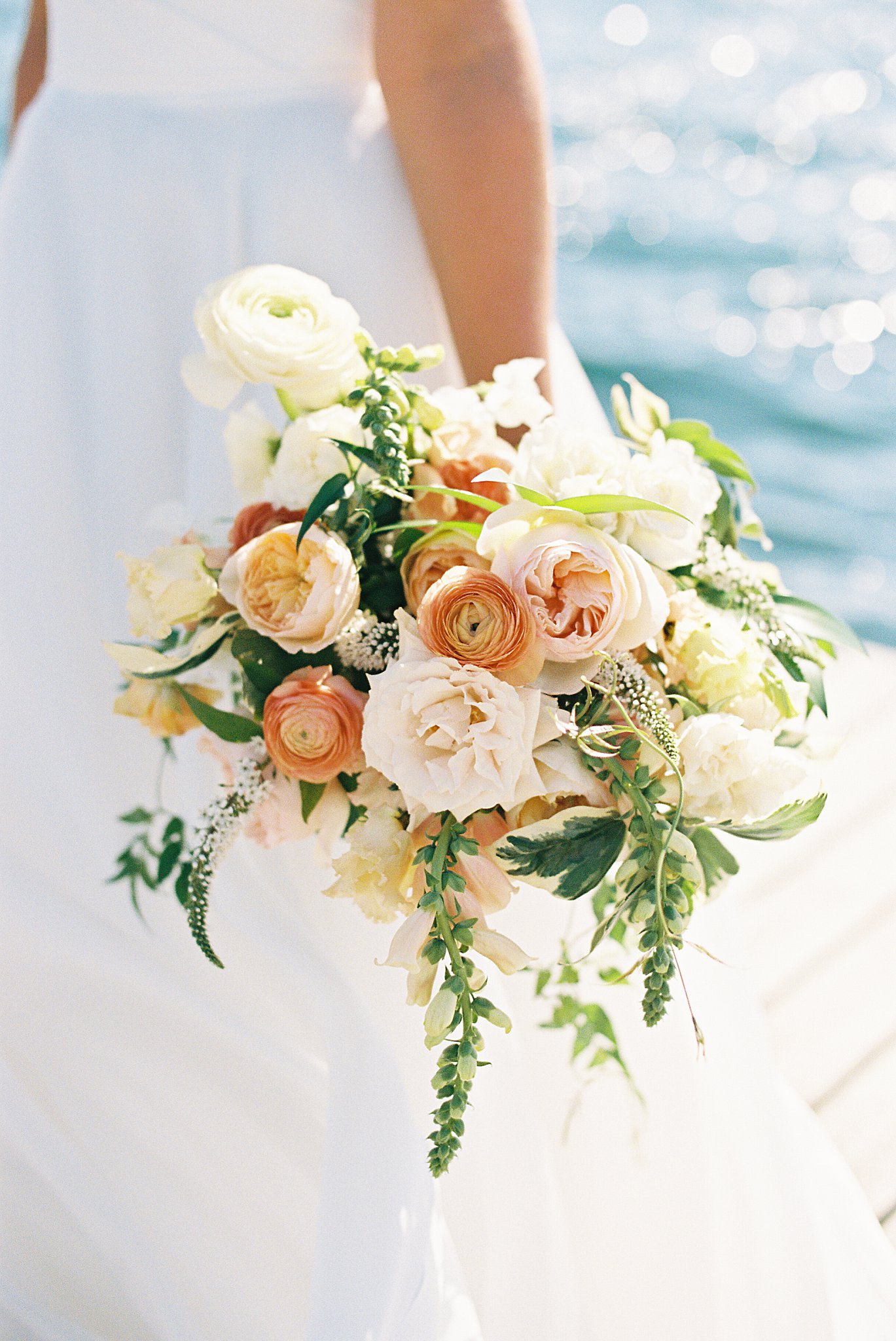 bridal florals with oranges and creams by Lynne Reznick Photography