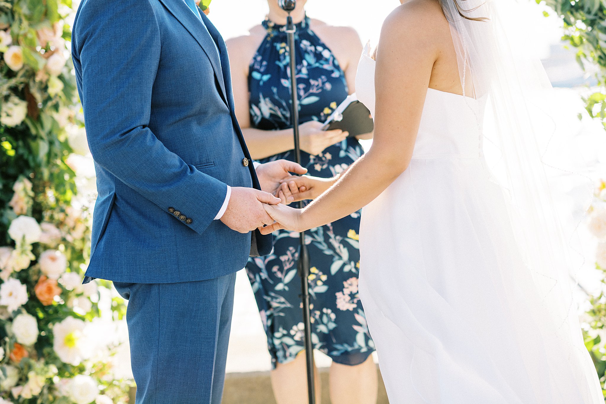 bride and groom hold hands at the altar at The Bohlin