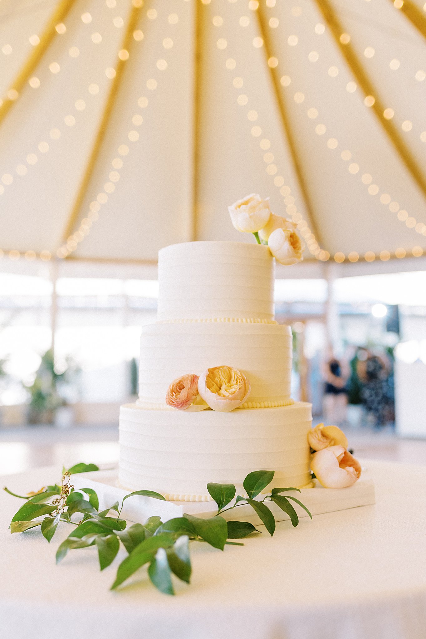 simple wedding cake decorated with peonies by Lynne Reznick Photography