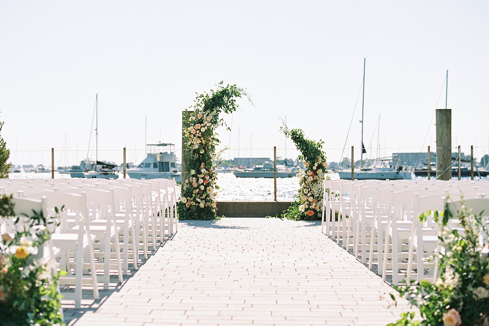 ceremony arch with lush florals by Boston wedding photographer