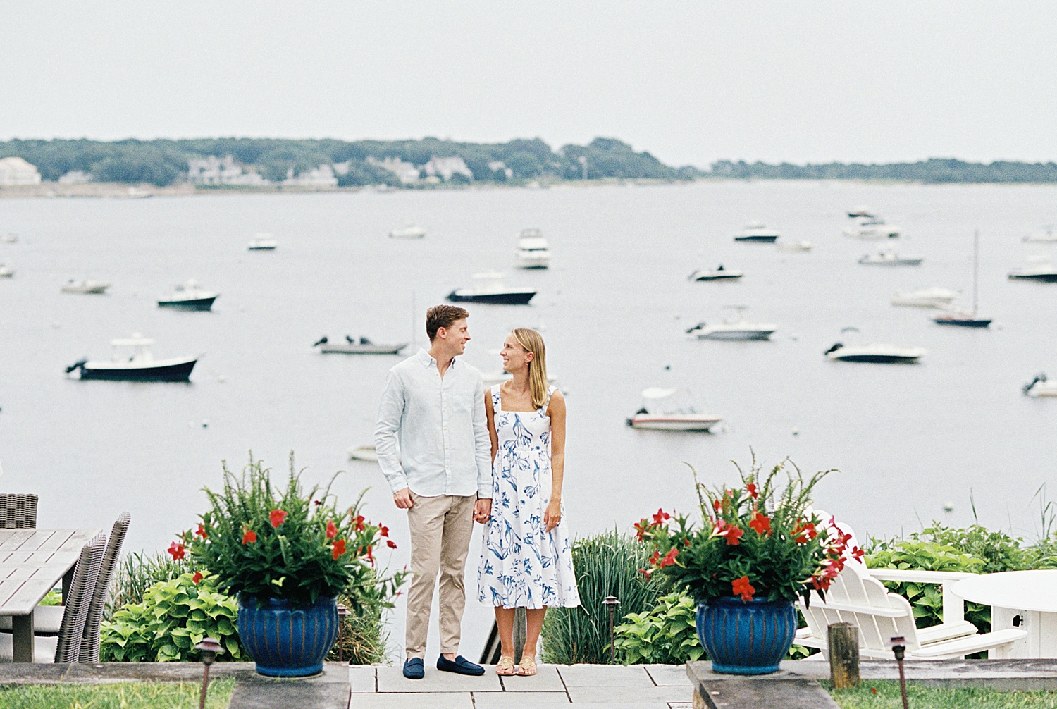 couple standing on dock gazing at each other by Lynne Reznick Photography