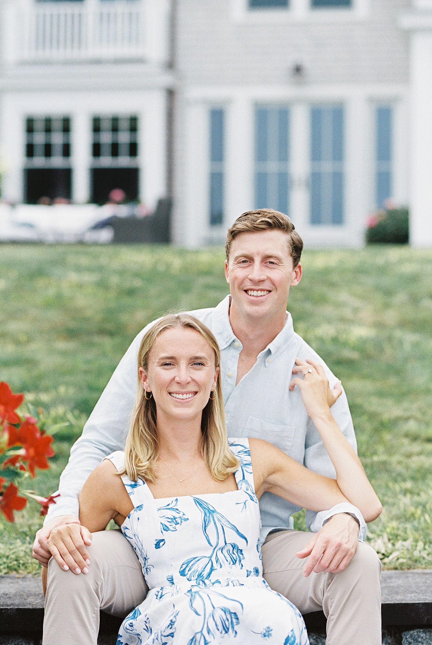 blonde couple sit together on cozy lawn by Lynne Reznick Photography