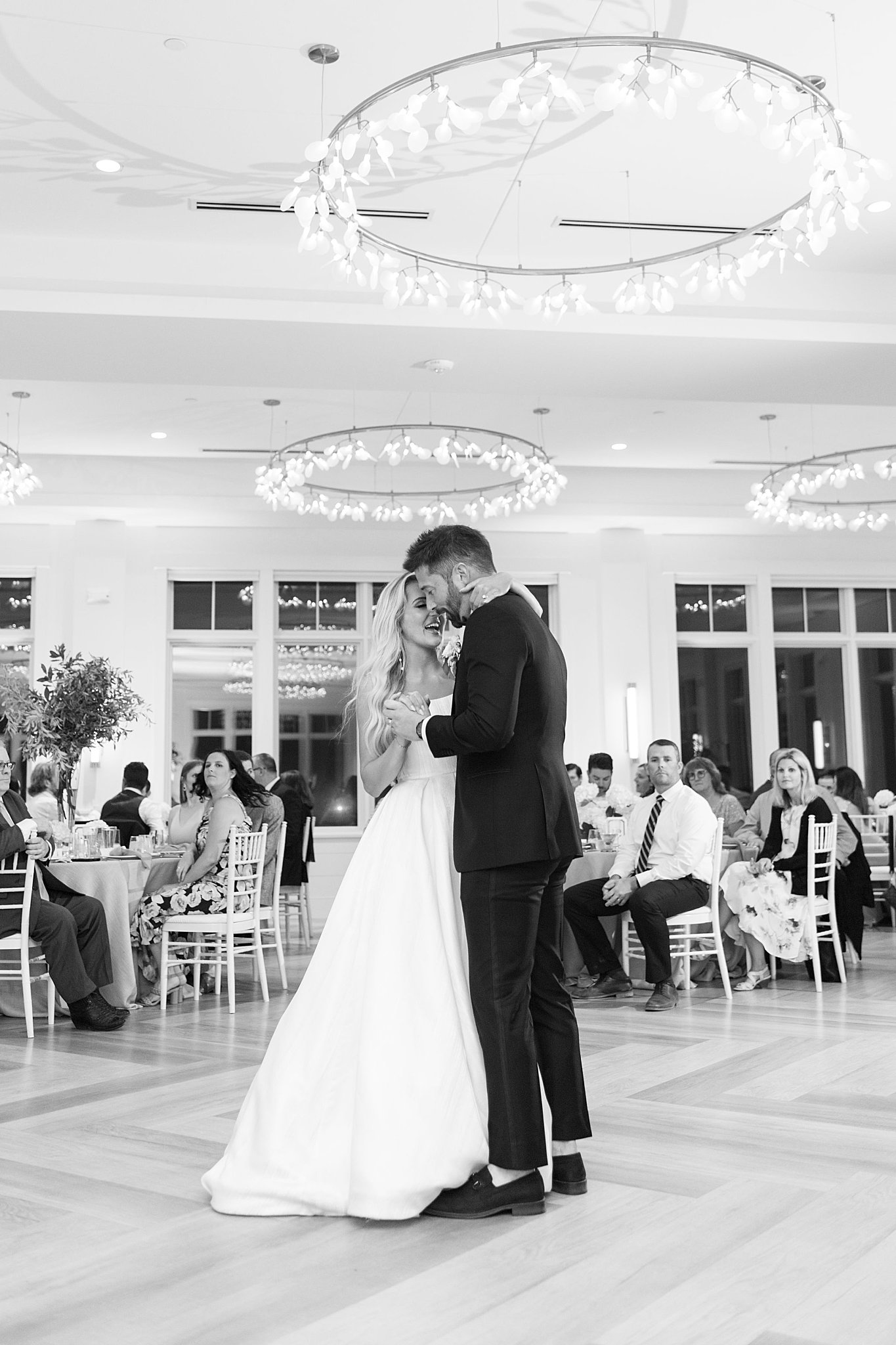 woman wraps hand around man's neck as they sway together by Boston wedding photographer