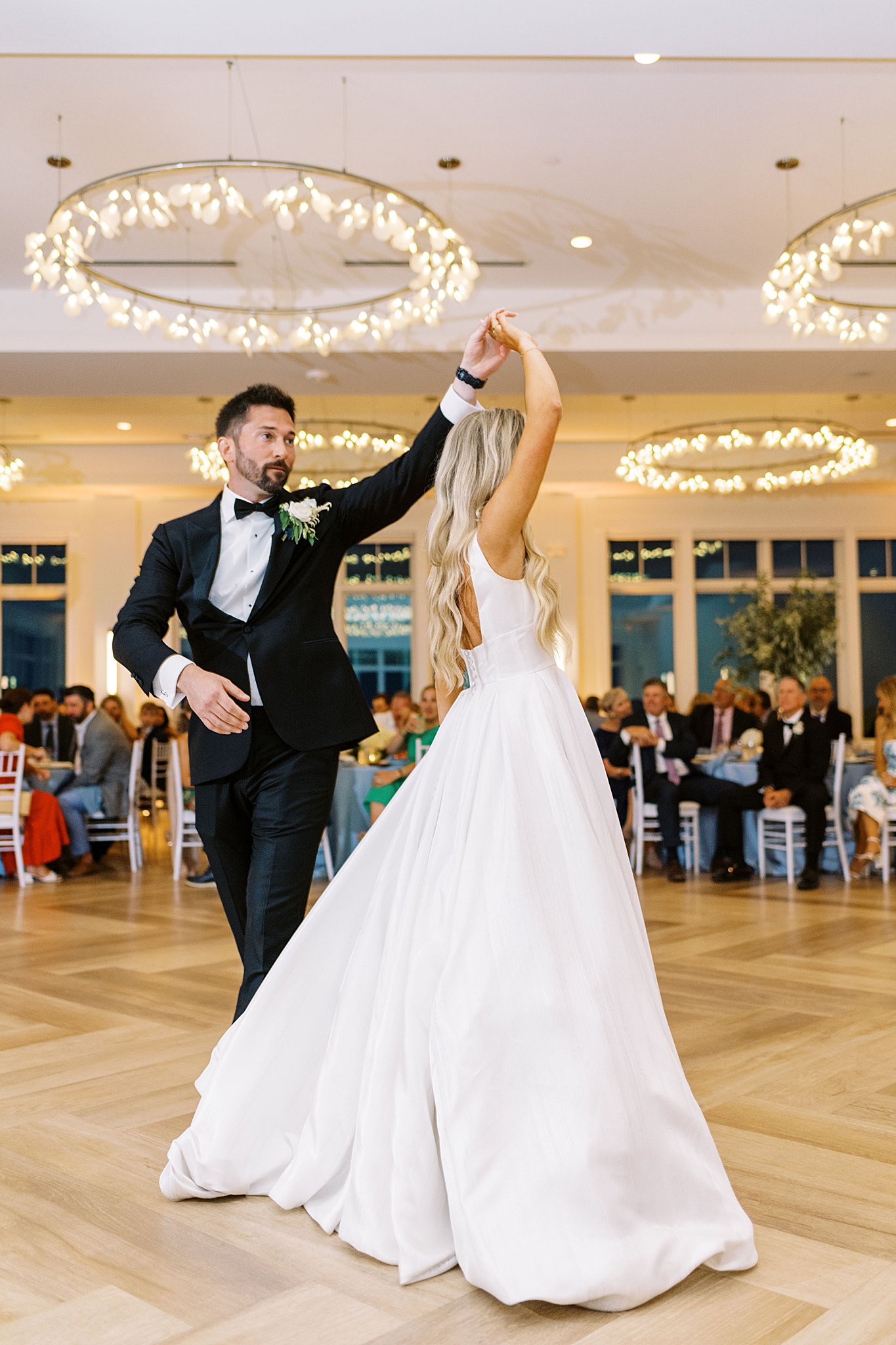 husband spins his new wife at the reception by Lynne Reznick Photography