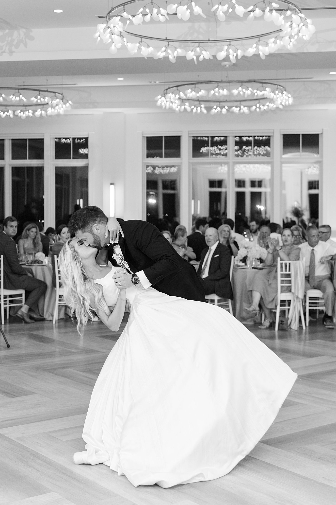 couple kiss as the man dips his wife on the dance floor by Lynne Reznick Photography