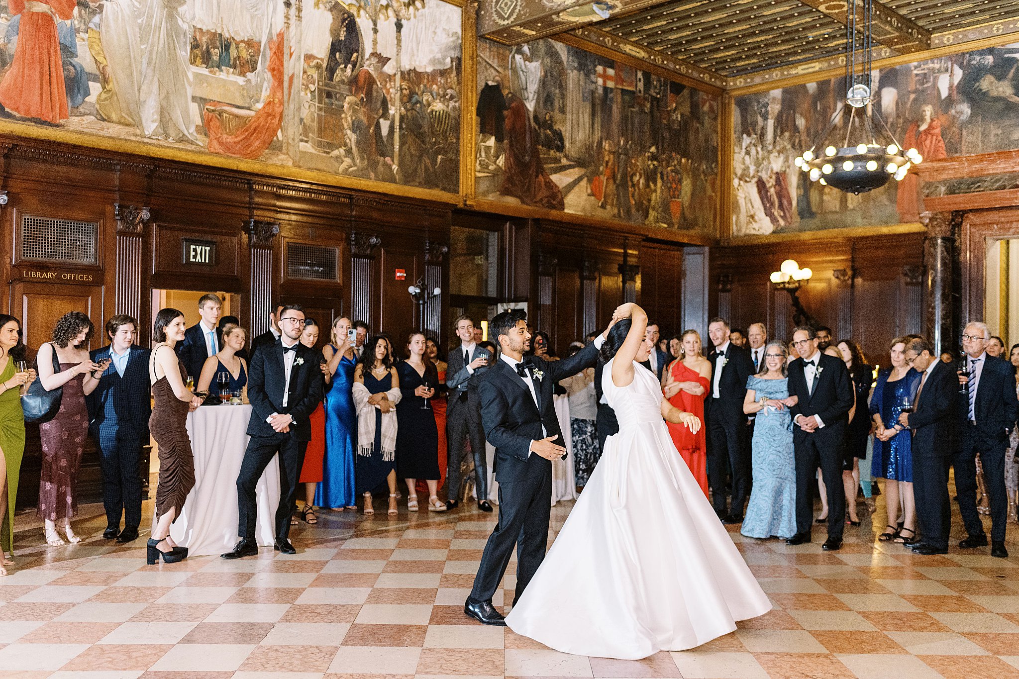 man spins his new wife as guests watch by Boston wedding photographer