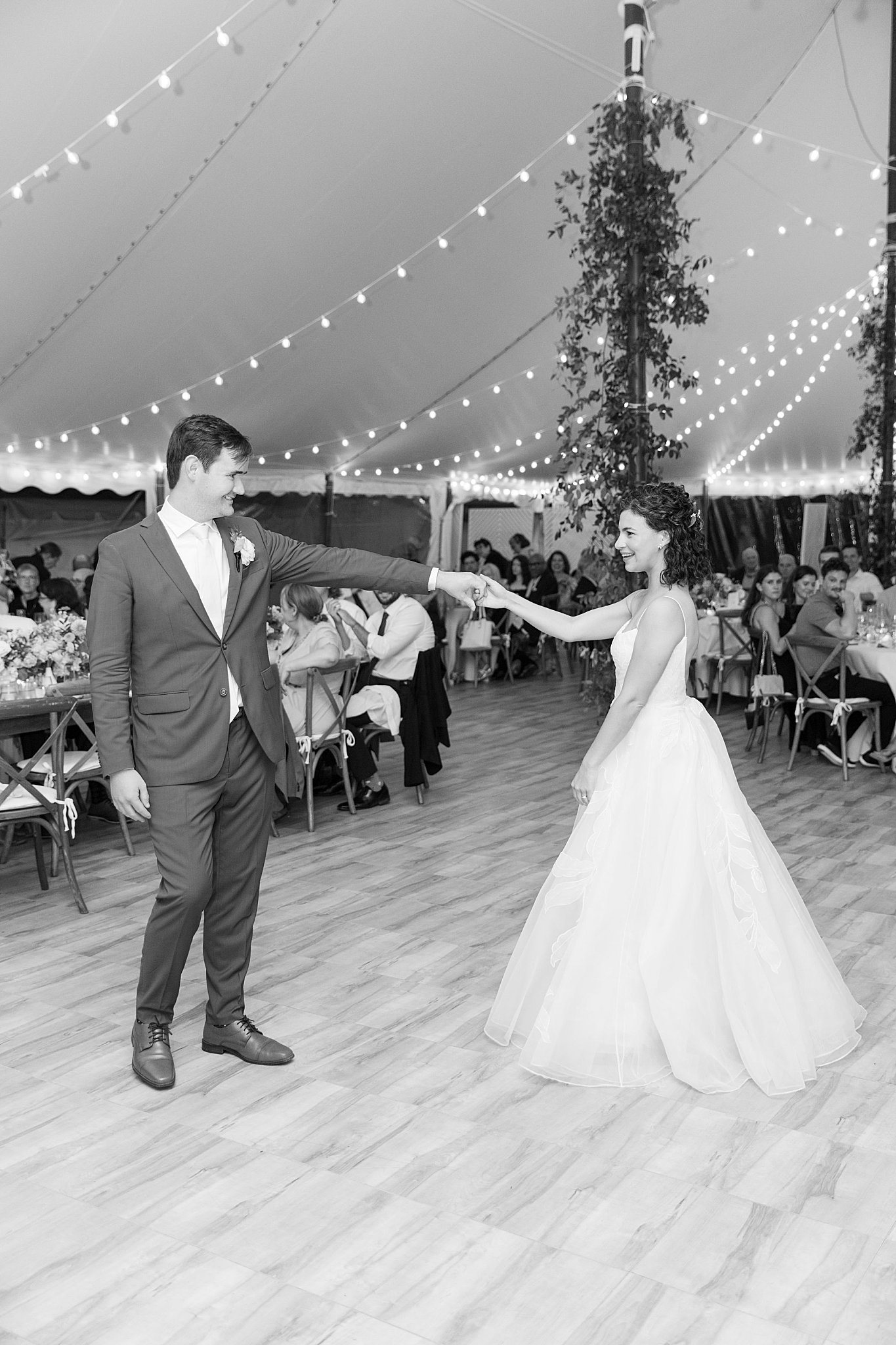 bride and groom hold hands at first dance