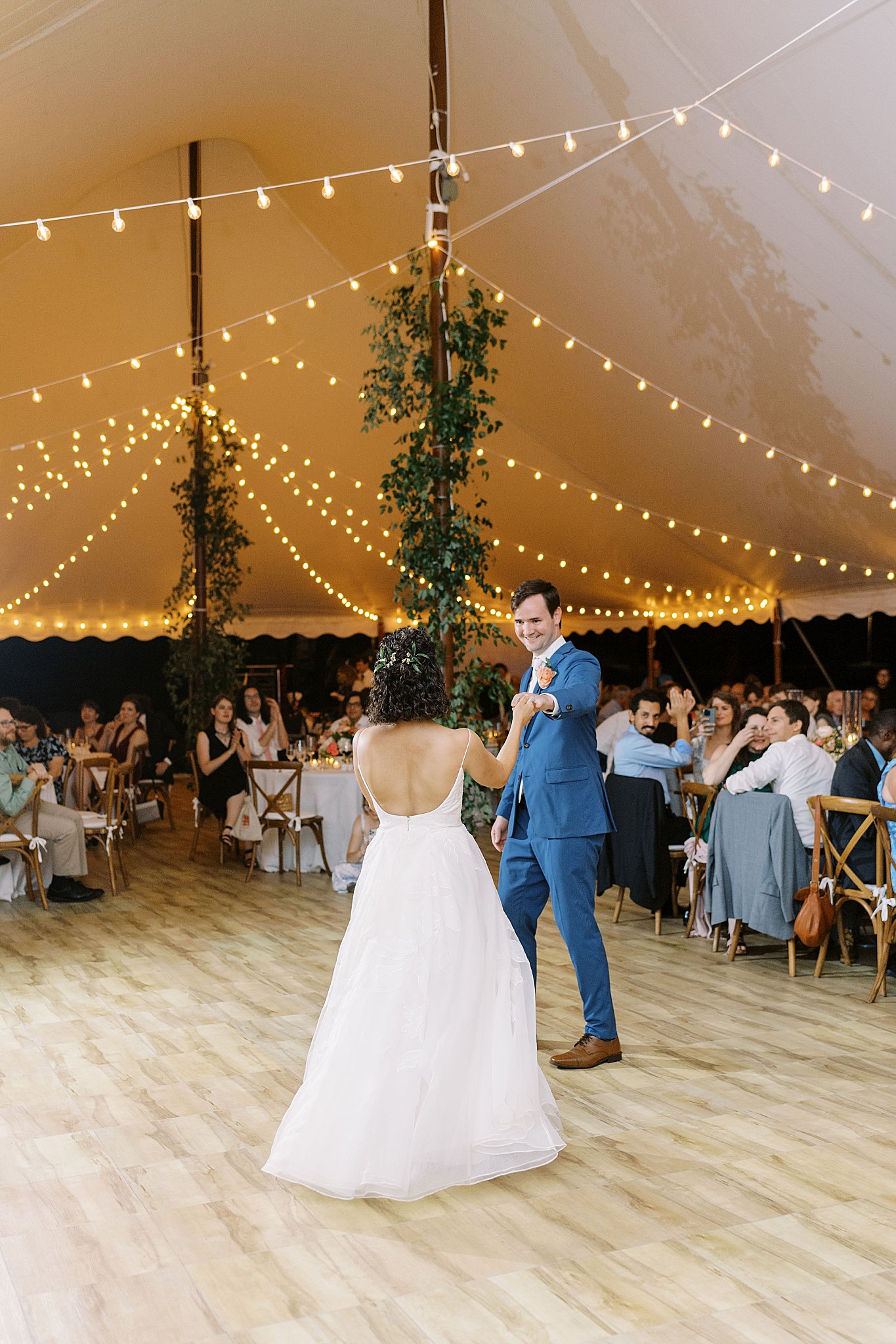 groom smiles at bride during first dance