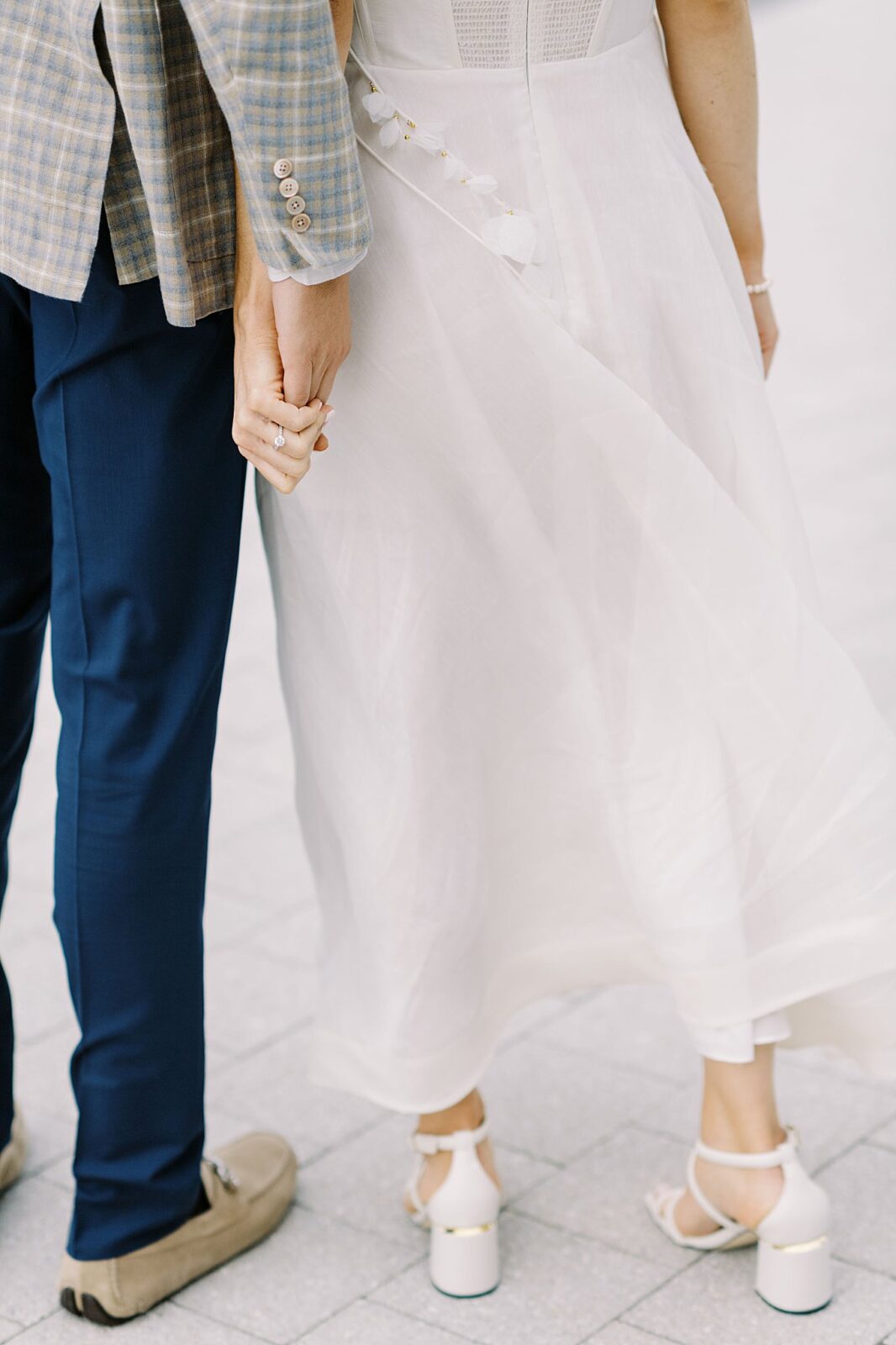 bride and groom hold hands at rehearsal by Boston wedding photographer