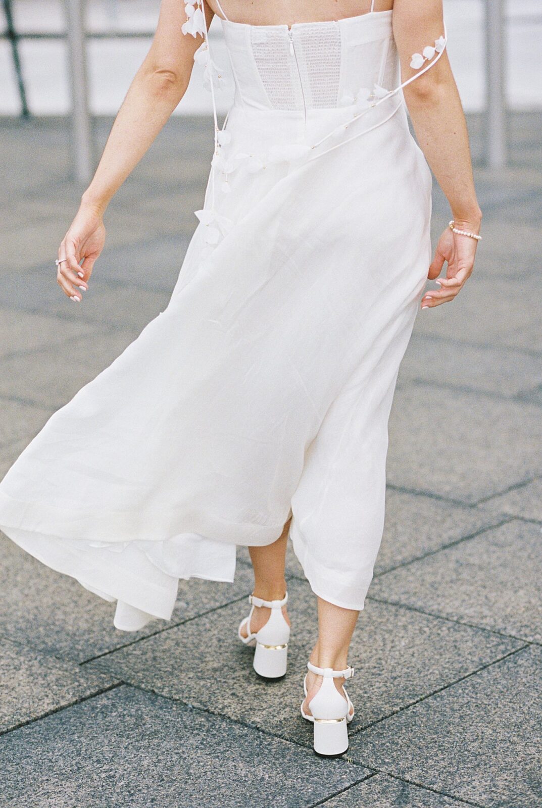 bride's dress blows in wind by Boston wedding photographer