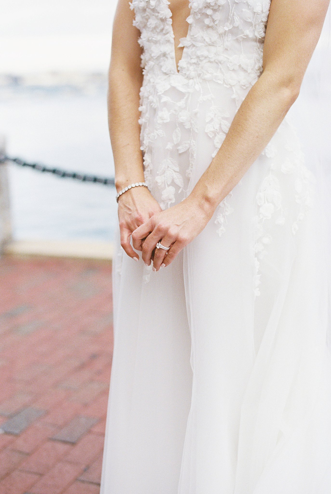 bride stands with hands in front by Lynne Reznick Photography 