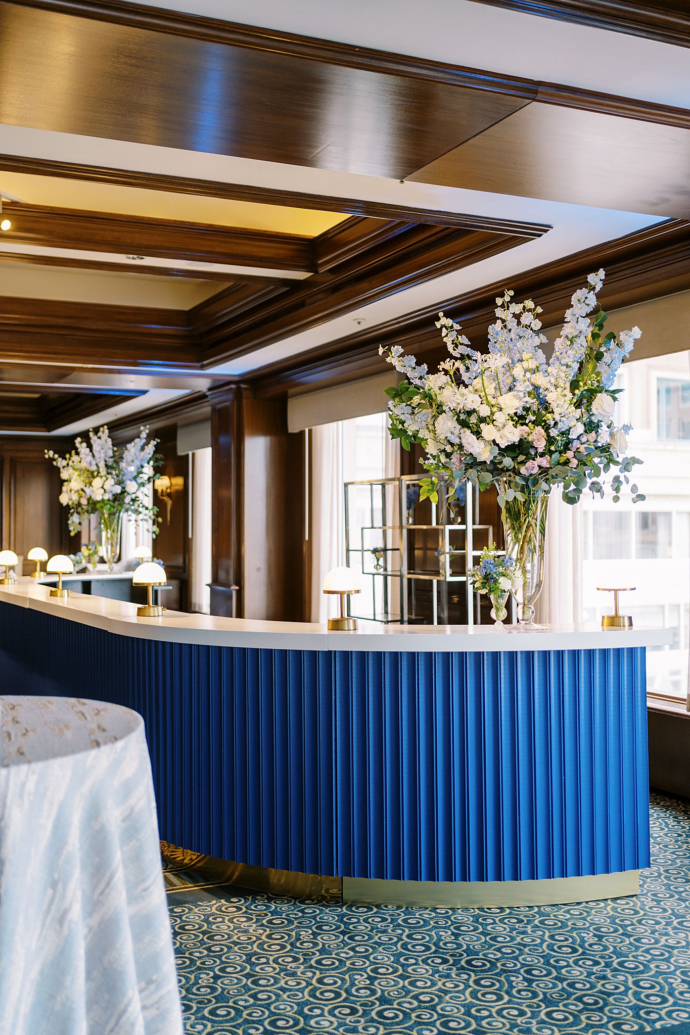 custom blue bar decorated with large florals by Boston wedding photographer