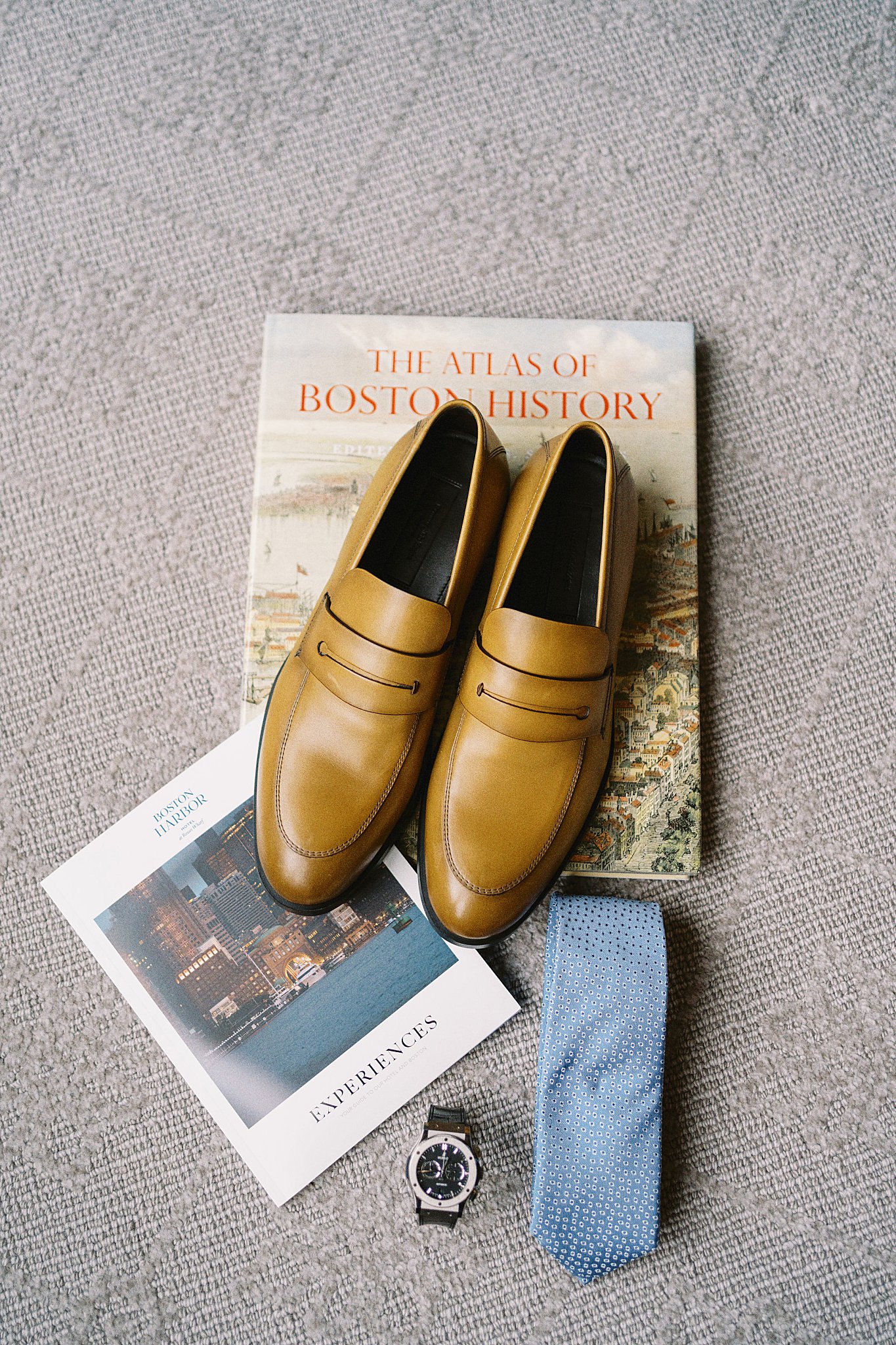 groom attire sits on books at Boston Harbor Hotel