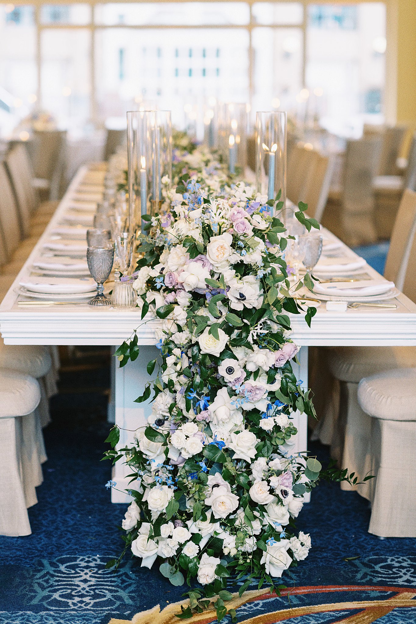 floral table running full of white, purple, and blue flowers by Boston wedding photographer