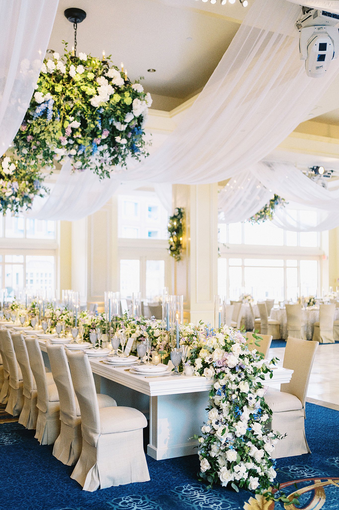 ballroom decorated with draperies and florals by Boston wedding photographer