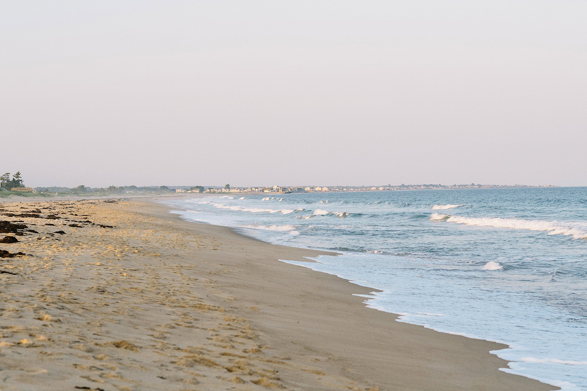 waves roll in along beach by New England photographer