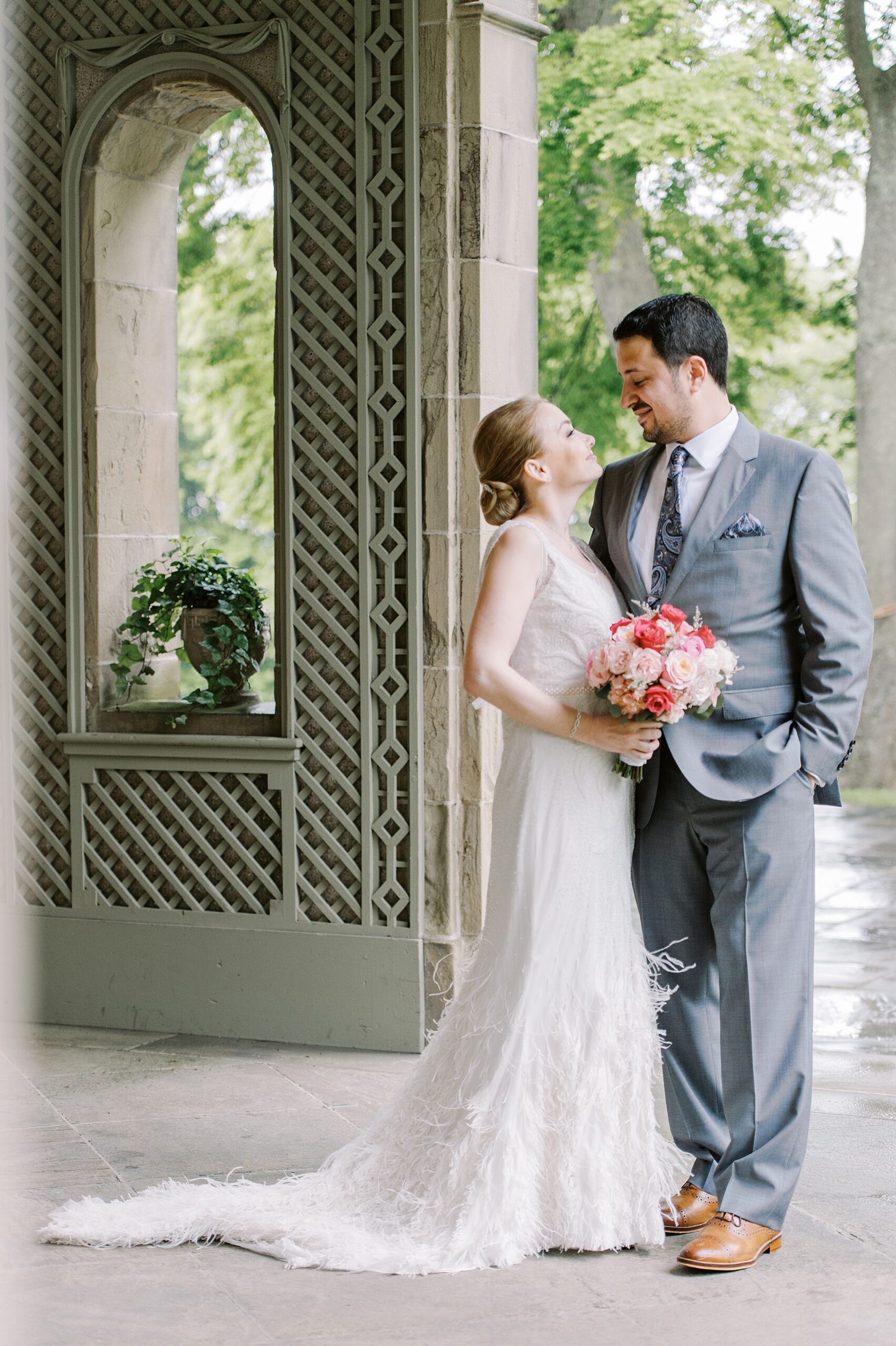 couple posing under portico at glen manor a european inspired wedding venue