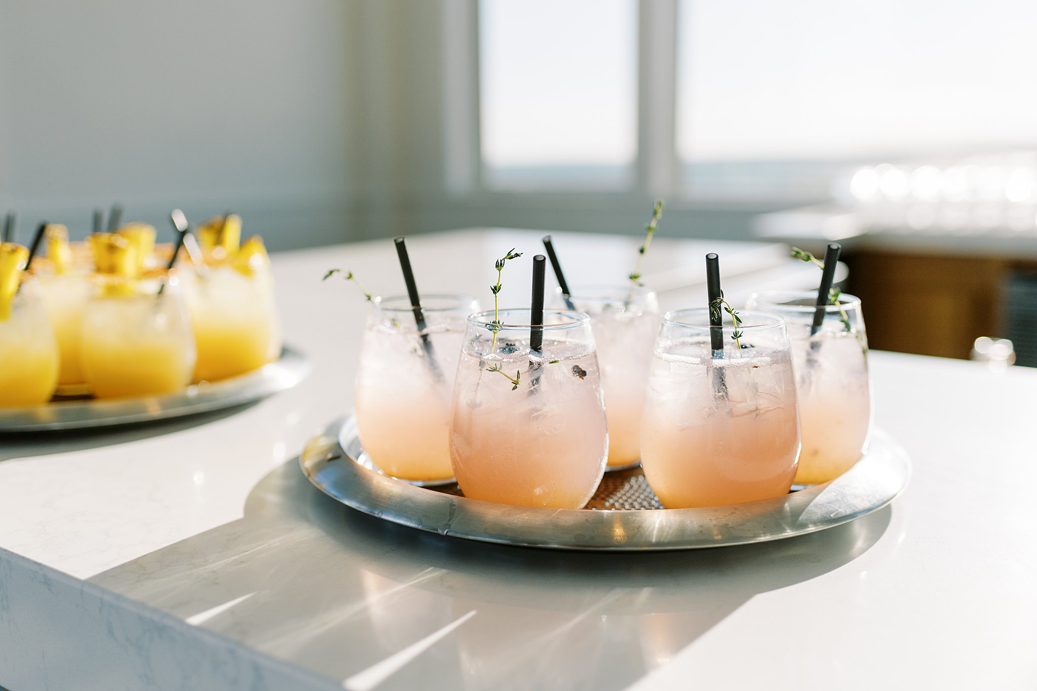 pink and orange cocktails wait for guests on bar by Cape Cod wedding photographer