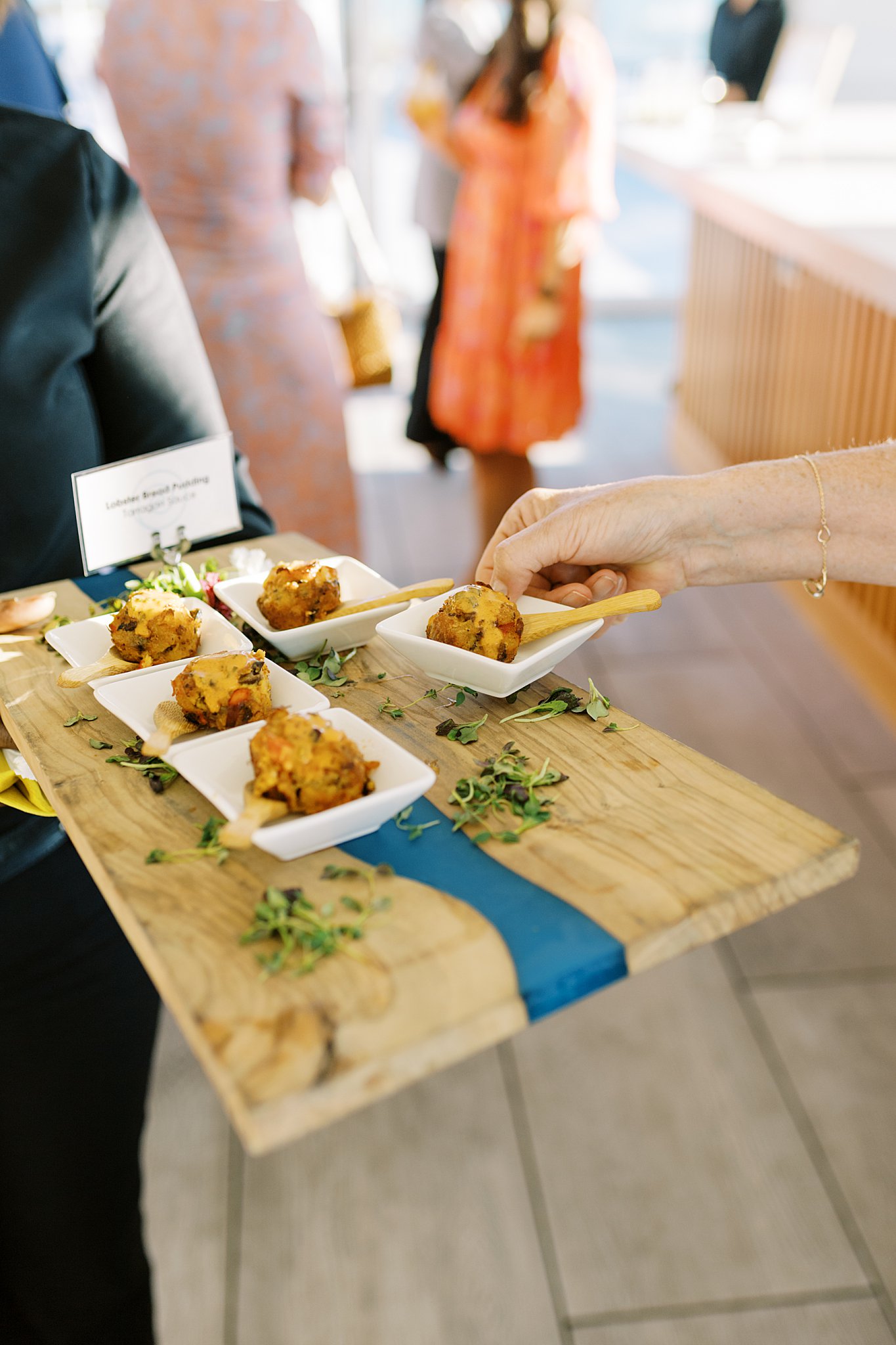 guest takes an appetizer from a passed tray by Lynne Reznick Photography